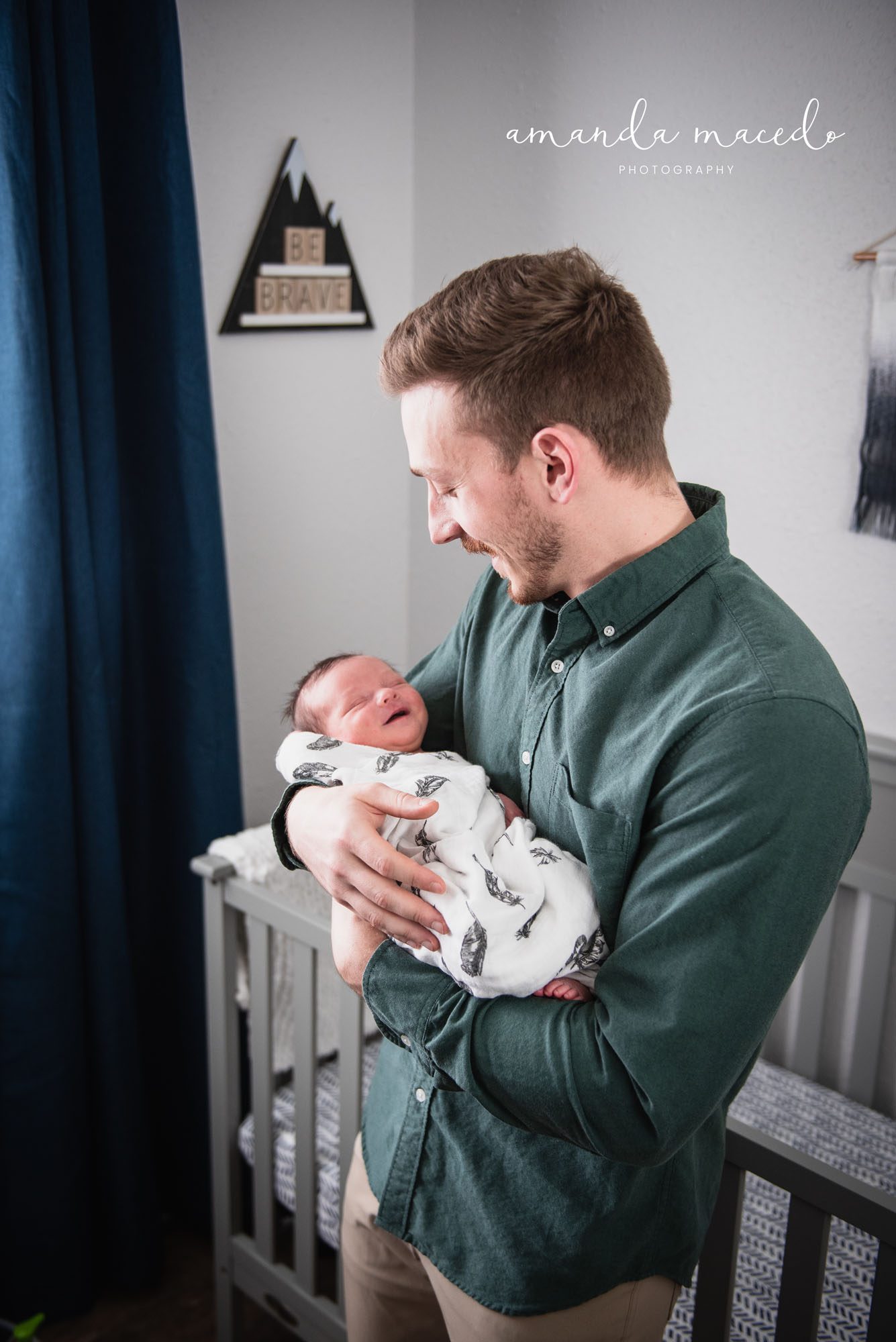 Newborn photographer, father holding smiling newborn baby