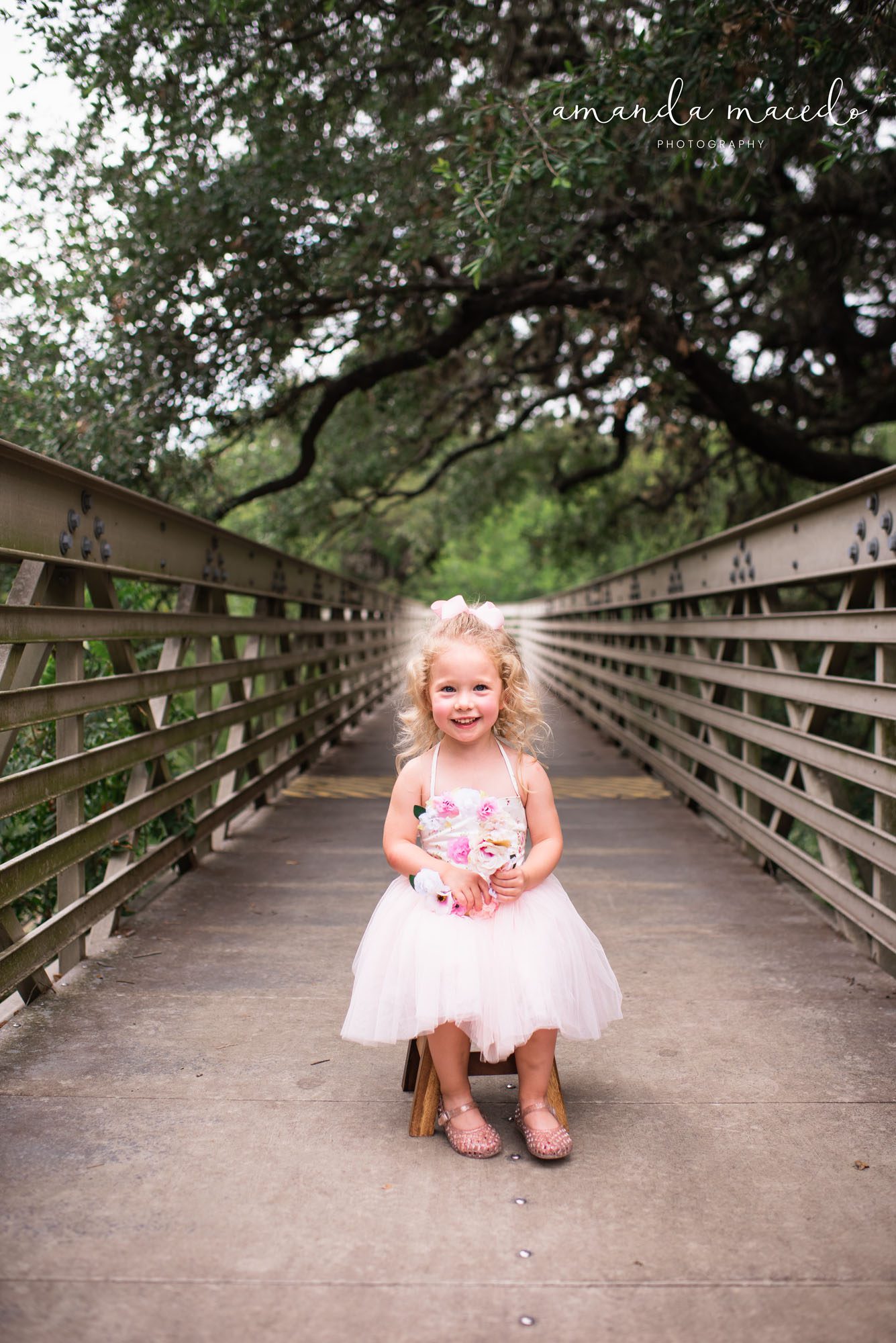 Child Photographer, 3 year old girl smiling on a bridge