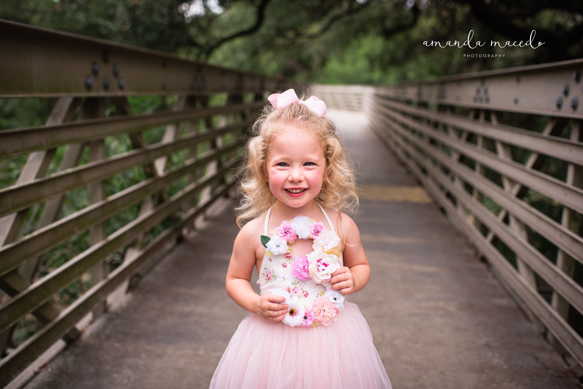 Child Photographer, little girl smiling on a bridge