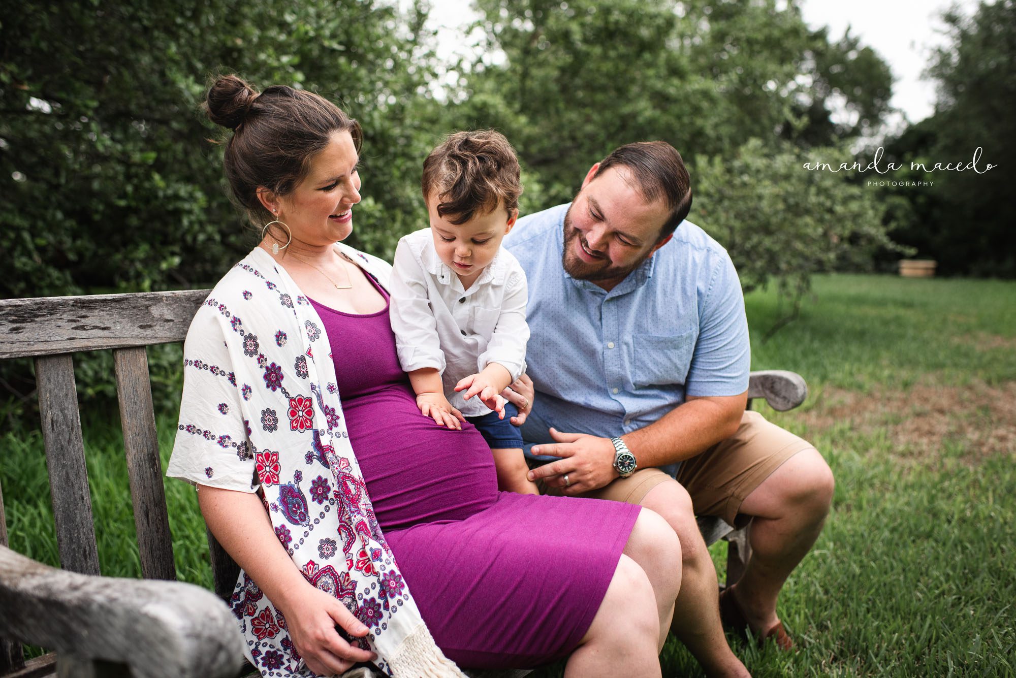 Maternity photographer, toddler touching mother's pregnant belly