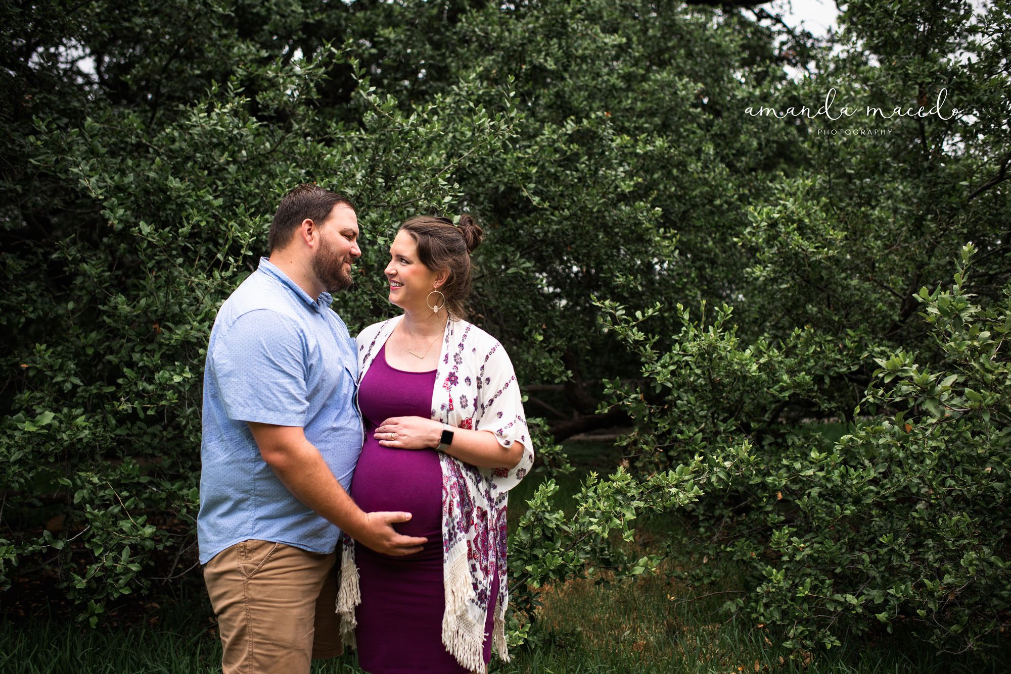 Maternity photographer, pregnant couple standing by a large tree