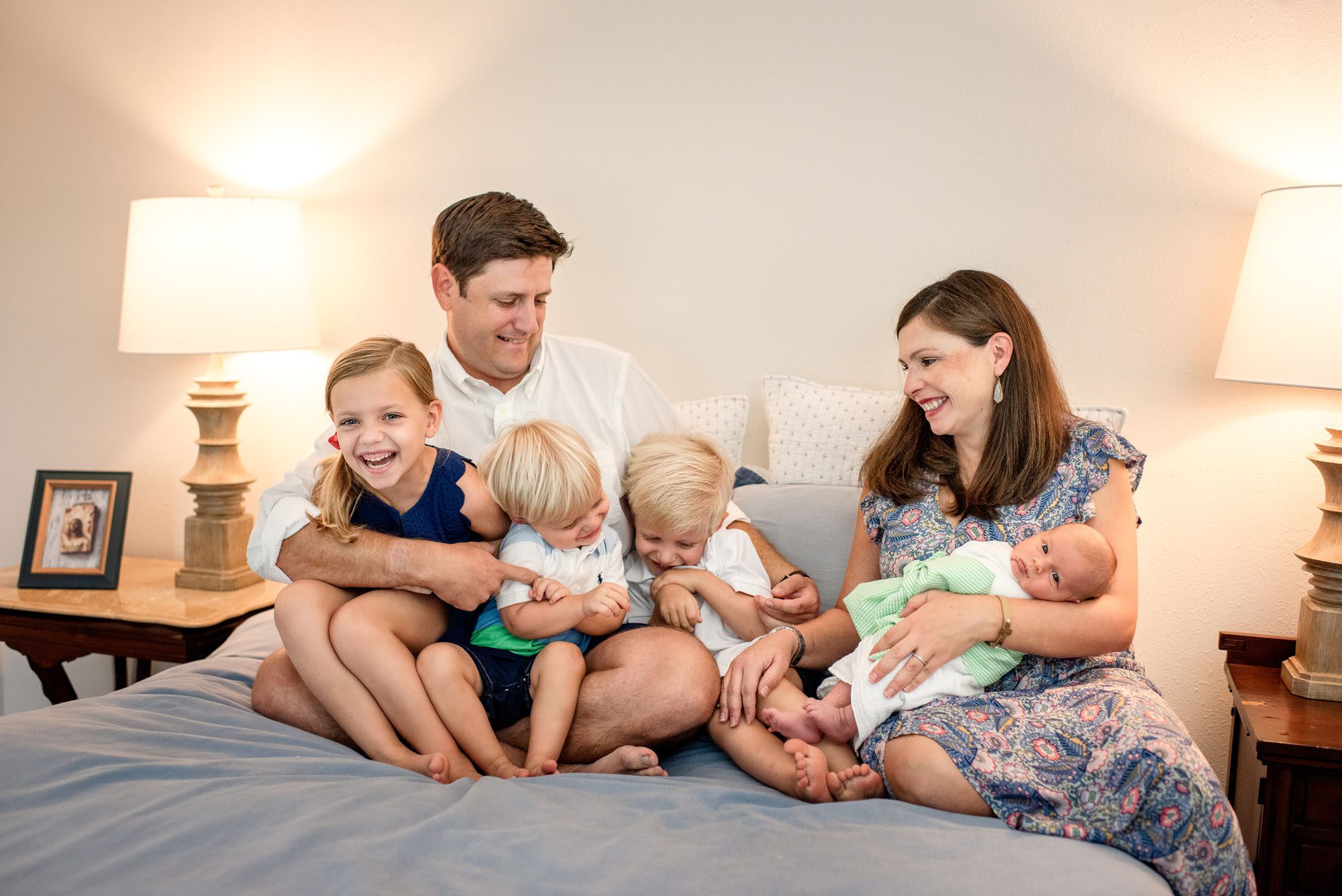 San Antonio newborn photographer, family on bed with newborn baby