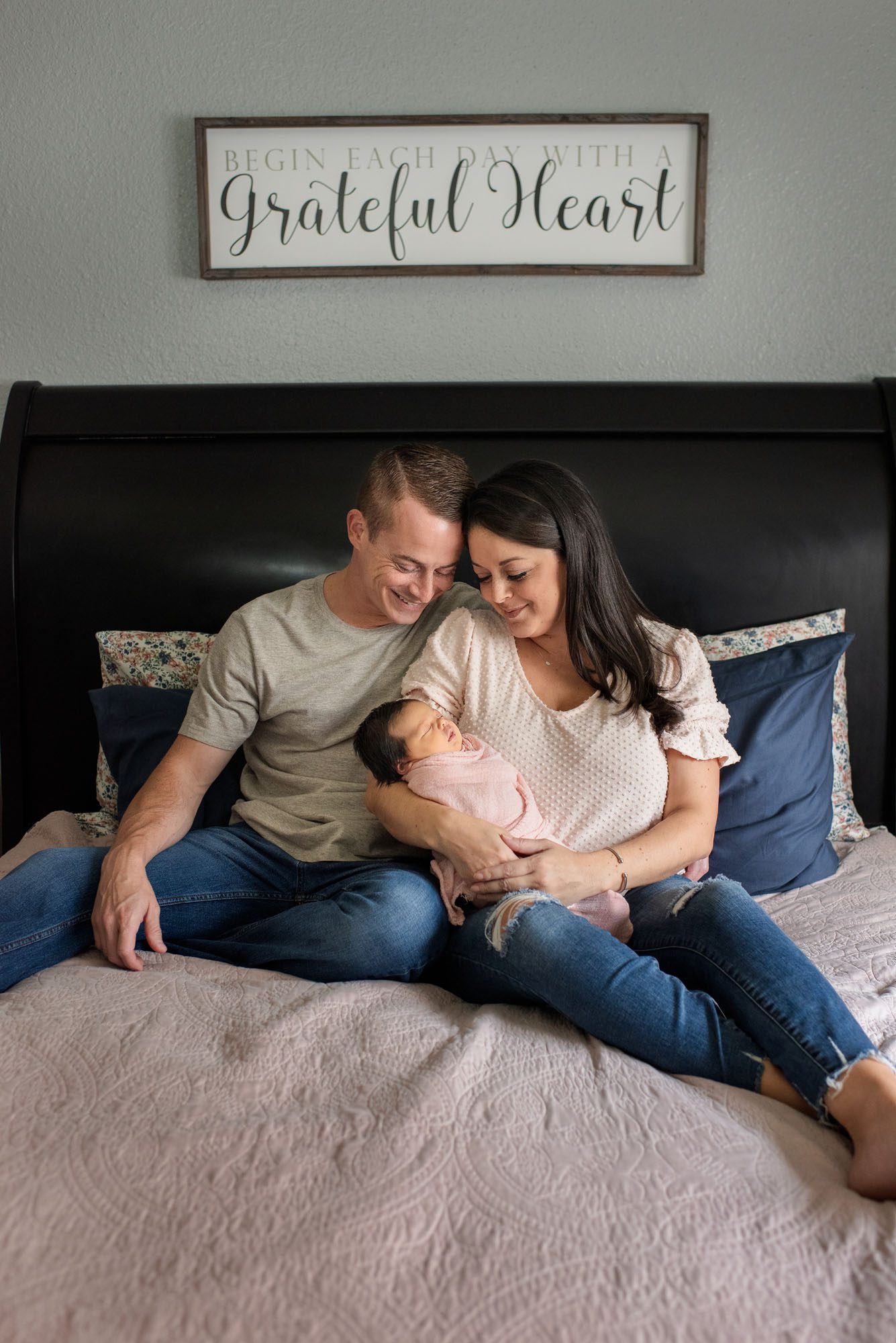 Parents holding newborn baby girl on bed, Lifestyle Newborn Photography San Antonio