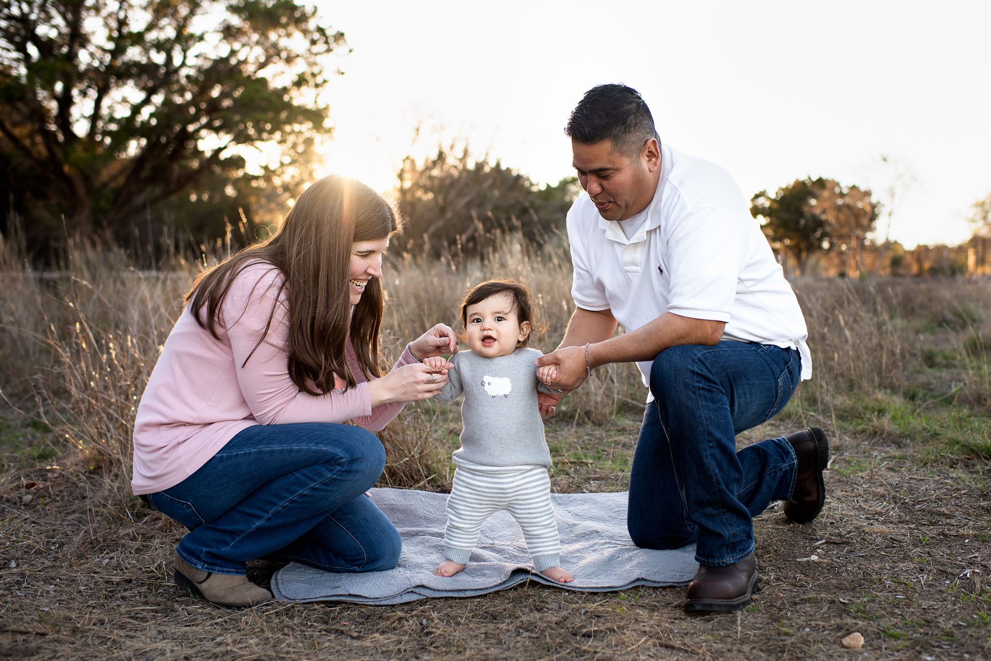 Parents helping baby stand up, San Antonio family photographer