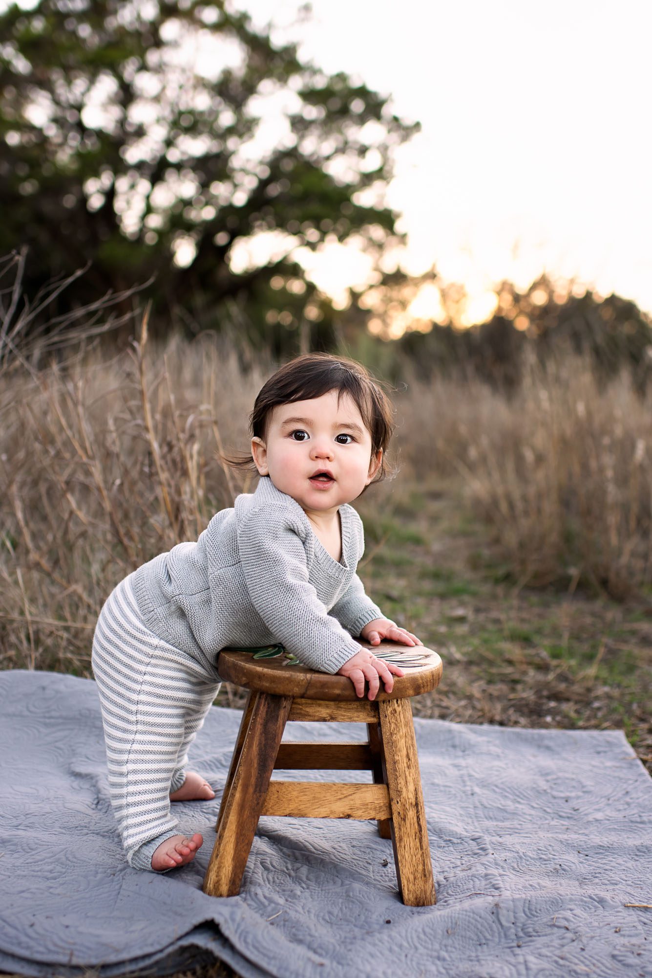 Baby standing by stool in field at sunset, San Antonio baby photographer
