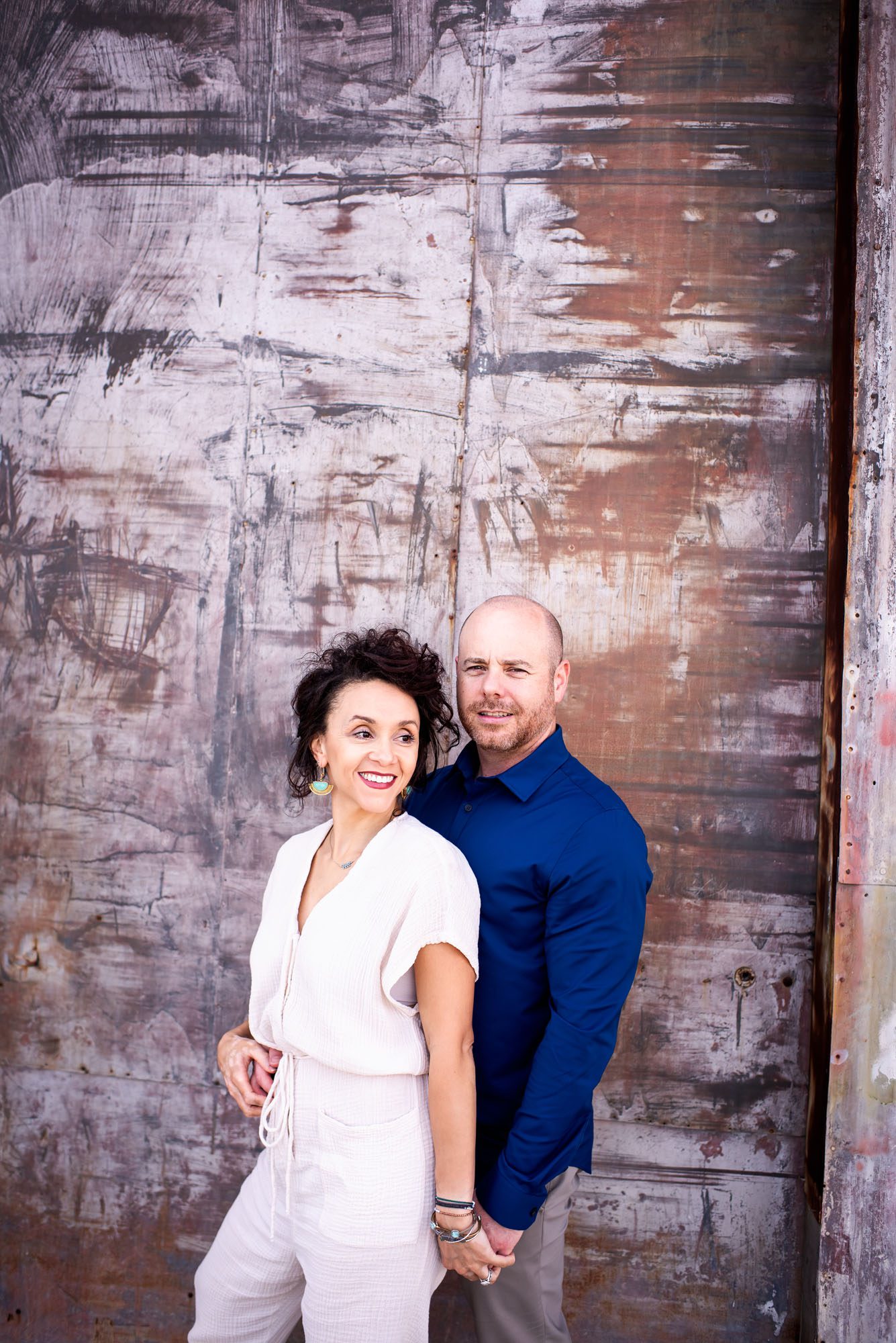 Couple in front of colorful wall, San Antonio lifestyle photographer