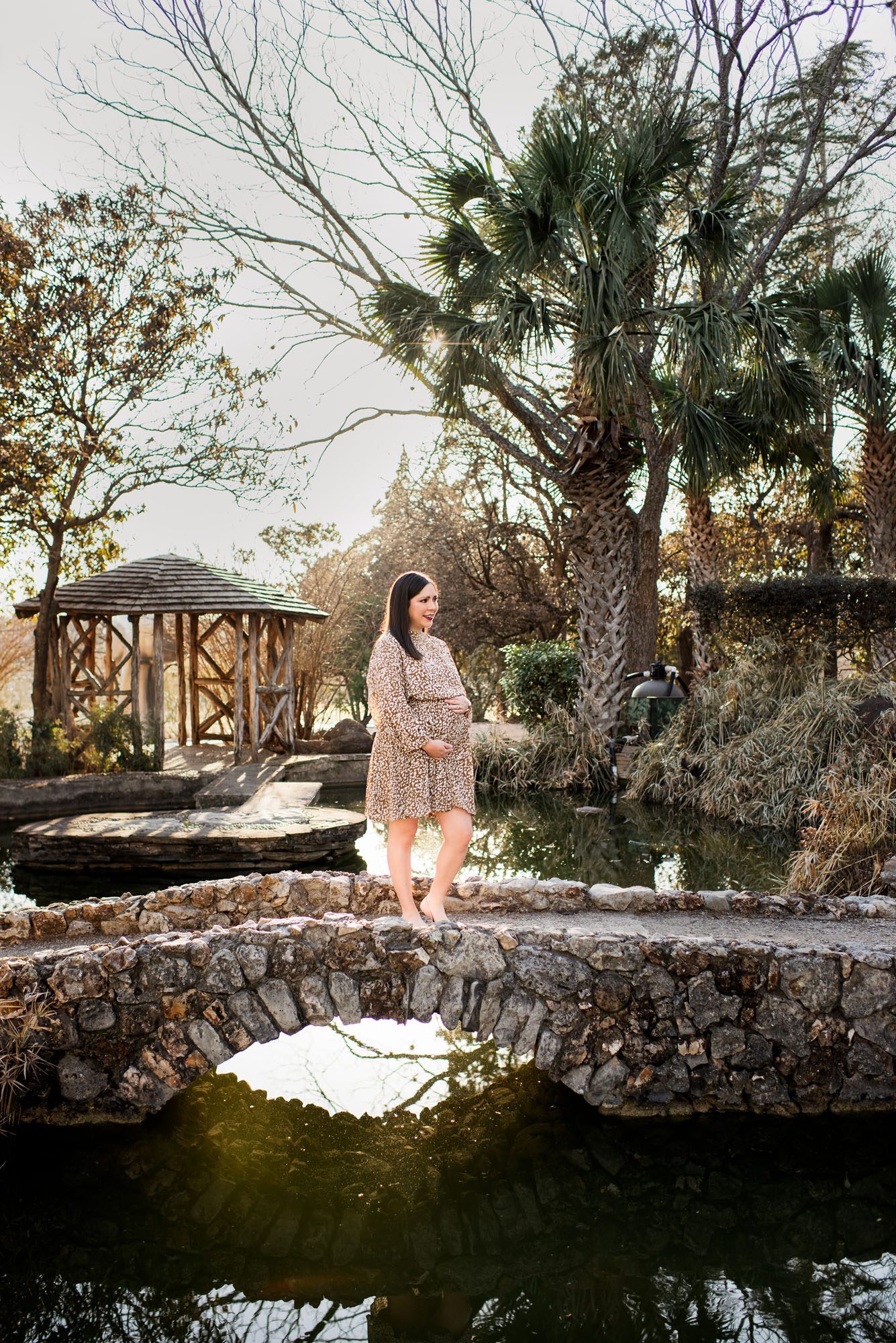 Pregnant mother standing on bridge, San Antonio maternity photographer