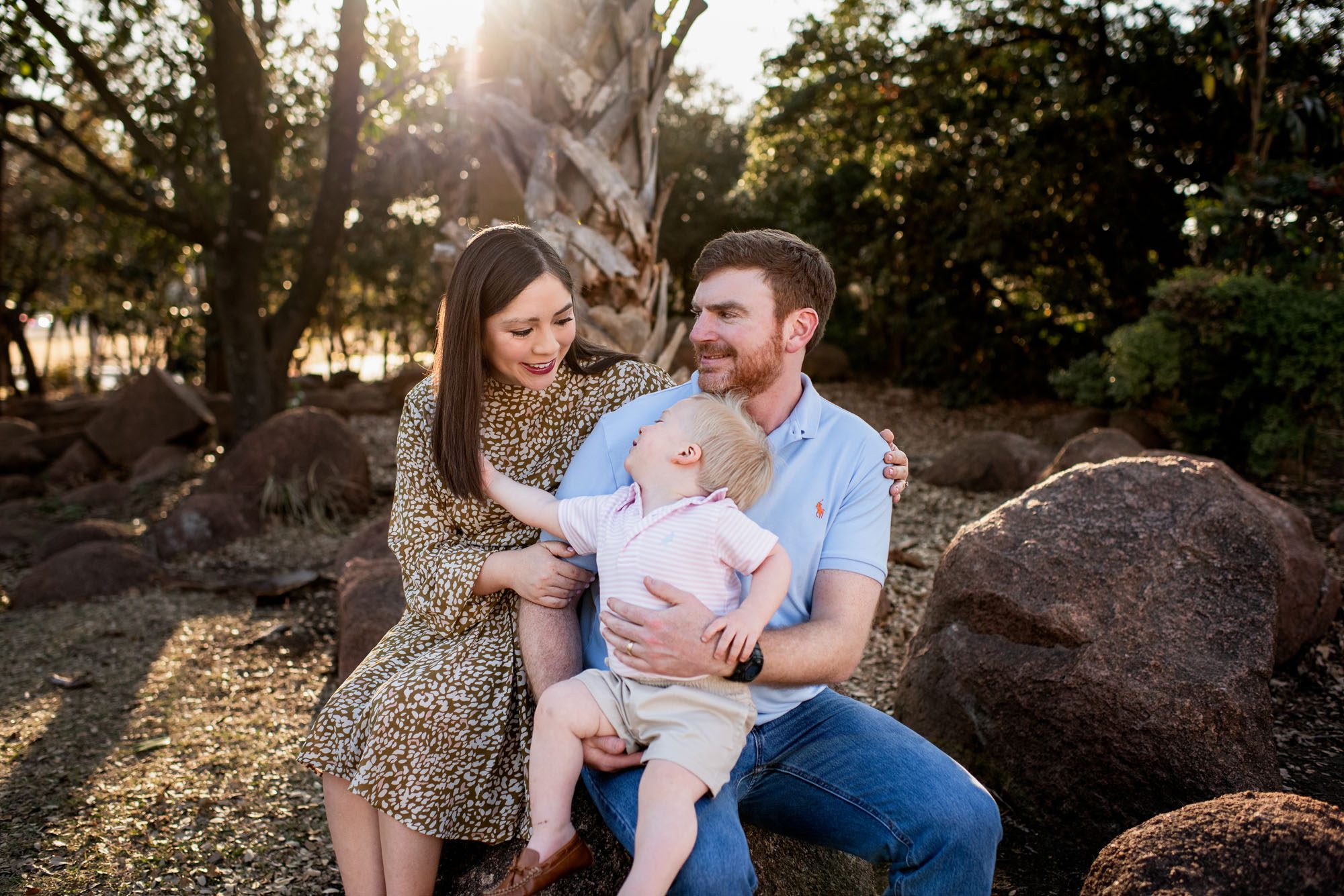 Family sitting together on a rock, San Antonio lifestyle maternity photographer