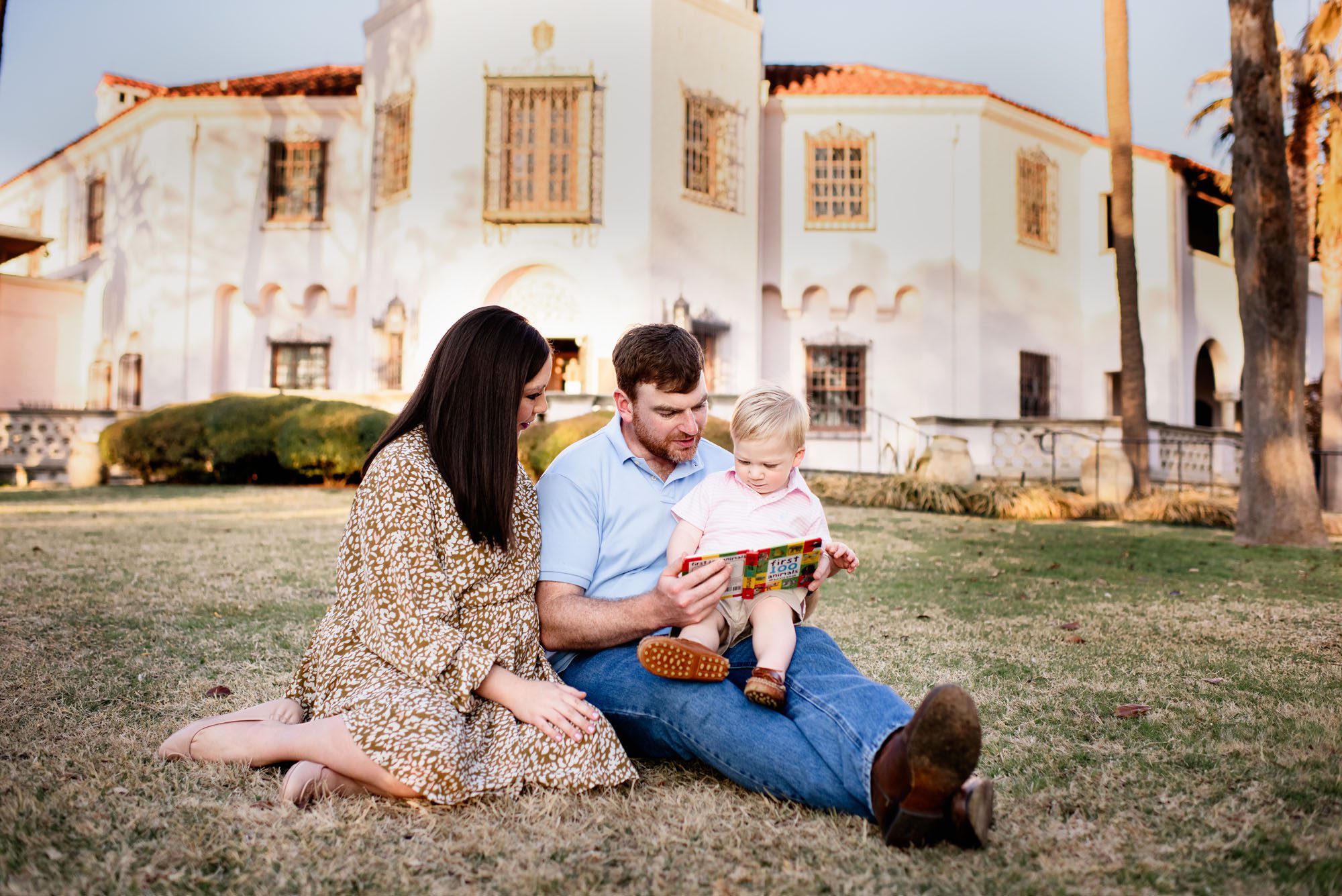 Family reading together on the grass, Best San Antonio lifestyle photographer