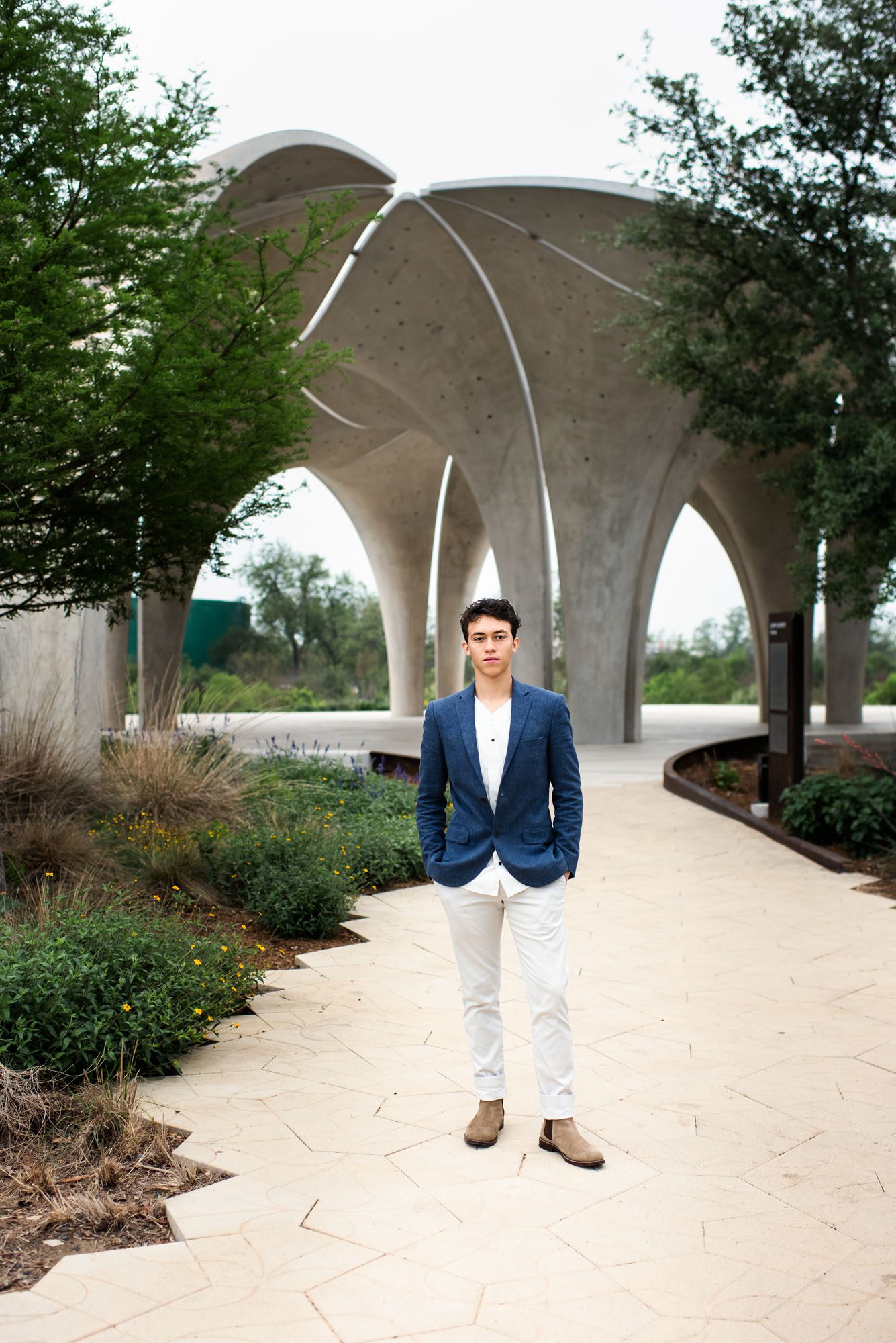 Senior boy standing by cement arch, San Antonio Senior Photographer