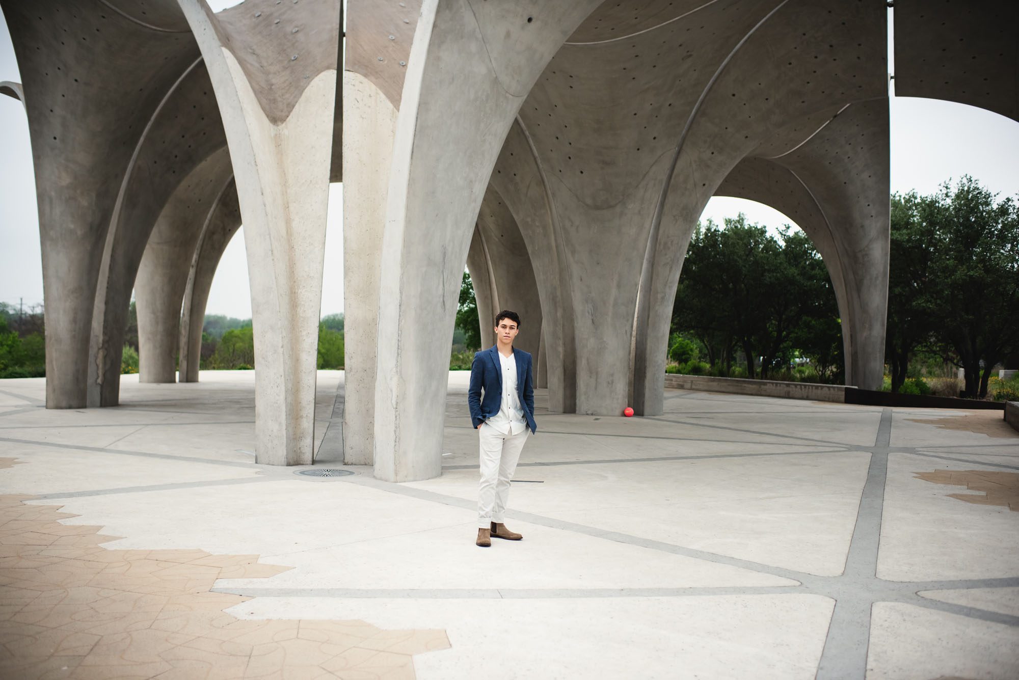 Boy standing by cement pavilion, San Antonio Senior Photographer