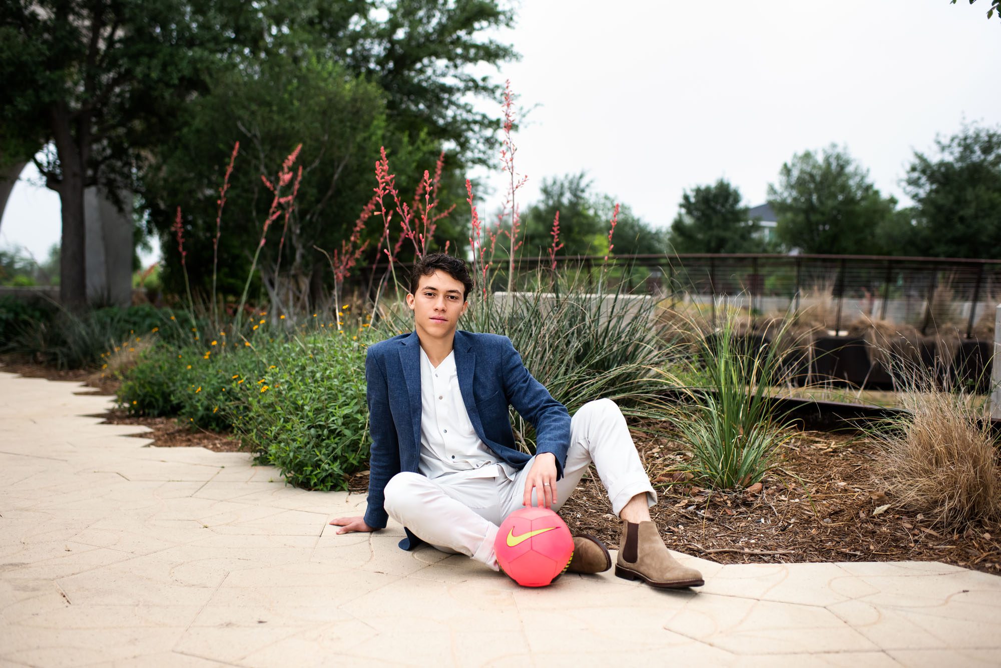 Boy sitting with pink soccer ball, San Antonio Senior Photographer