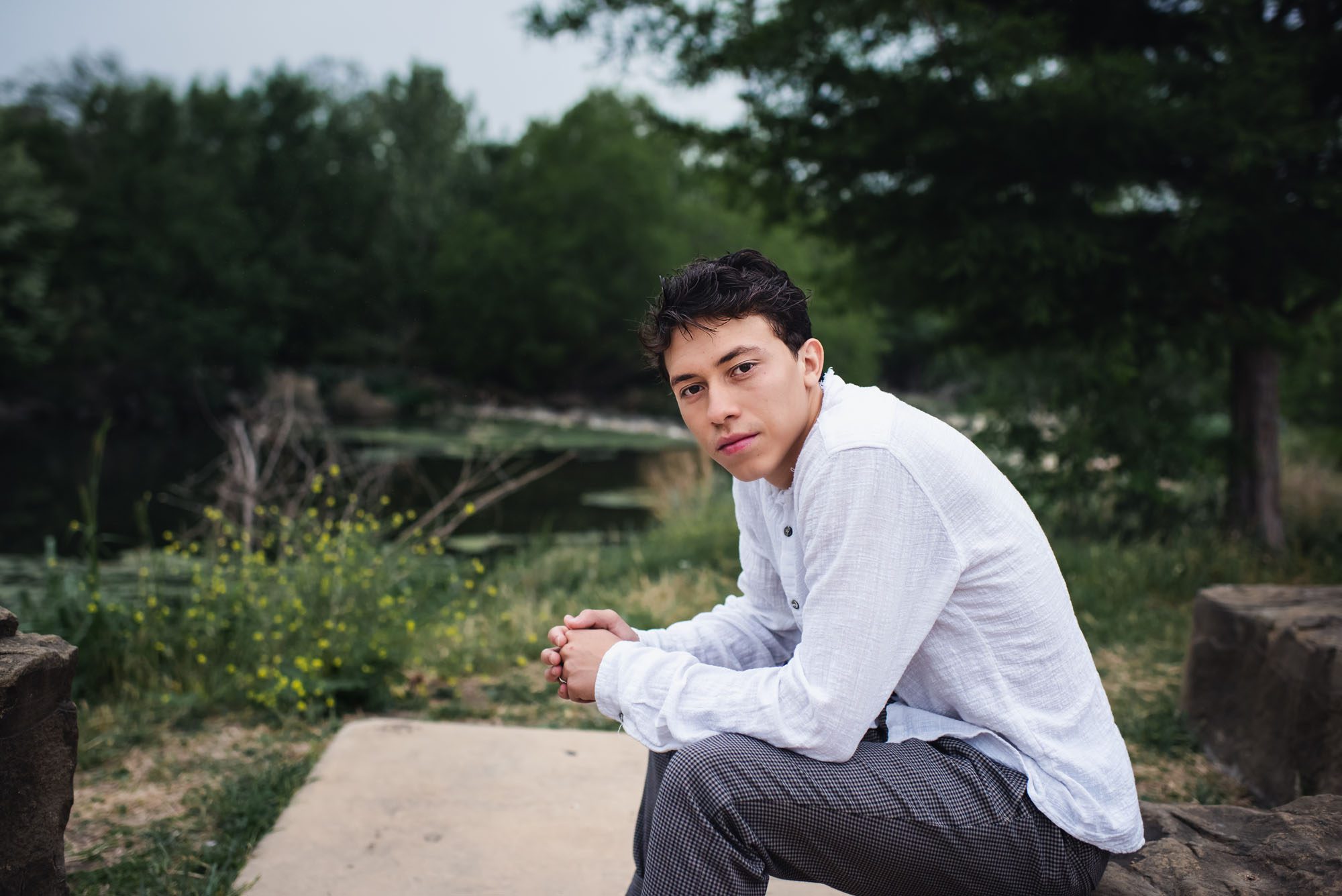 Boy sitting by the San Antonio River, Best Senior Photographer in San Antonio