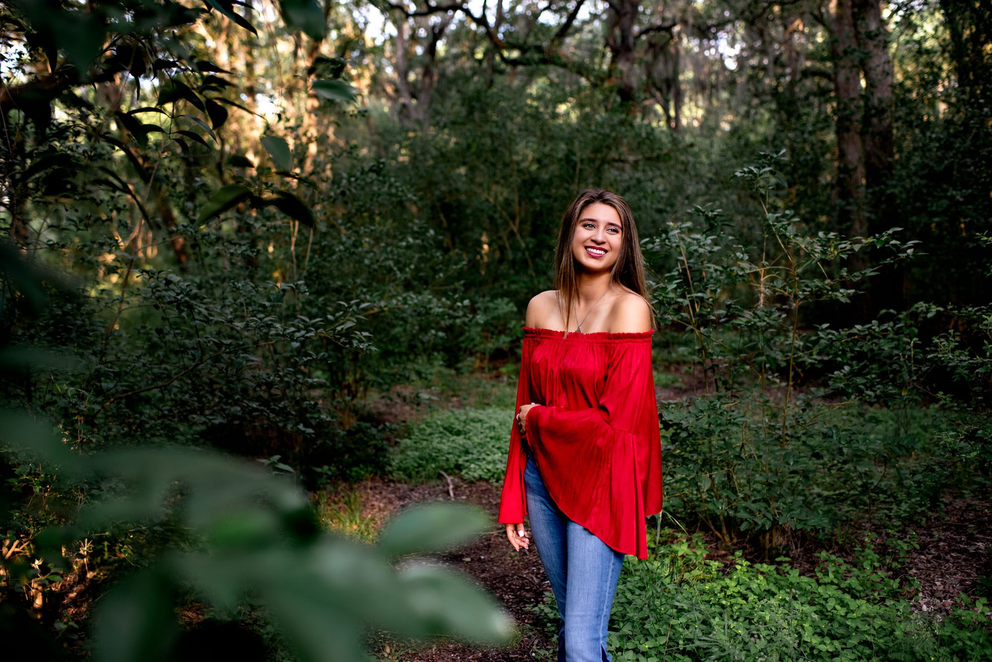 Girl in flowy red shirt standing in the woods, San Antonio Senior Photographer
