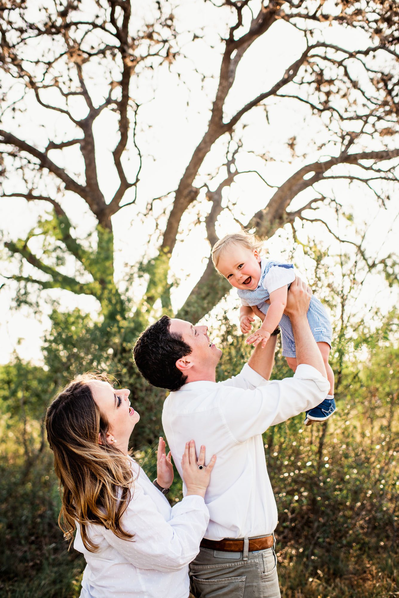 Parents holding baby in the air, San Antonio lifestyle family photographer