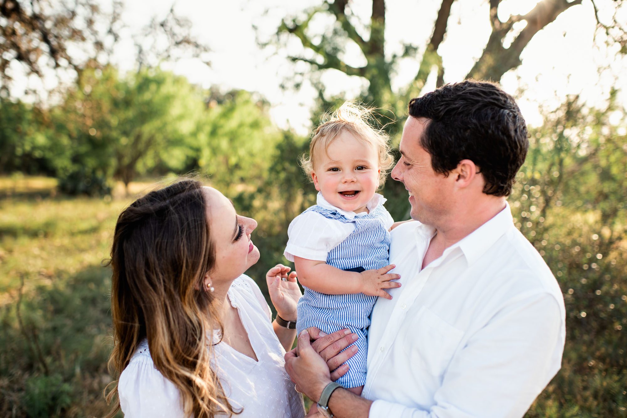 Family smiling at one another, San Antonio family photographer