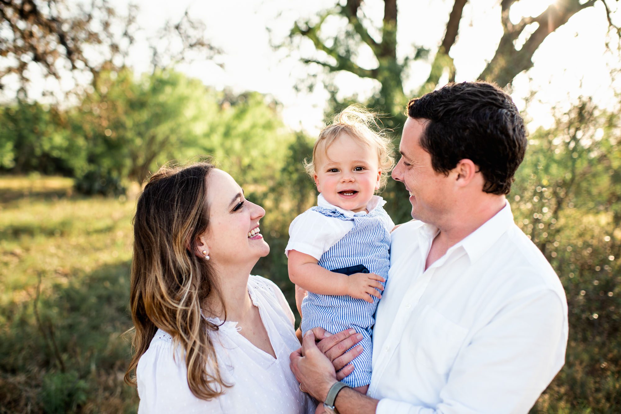 Family smiling at one another, San Antonio family lifestyle photographer