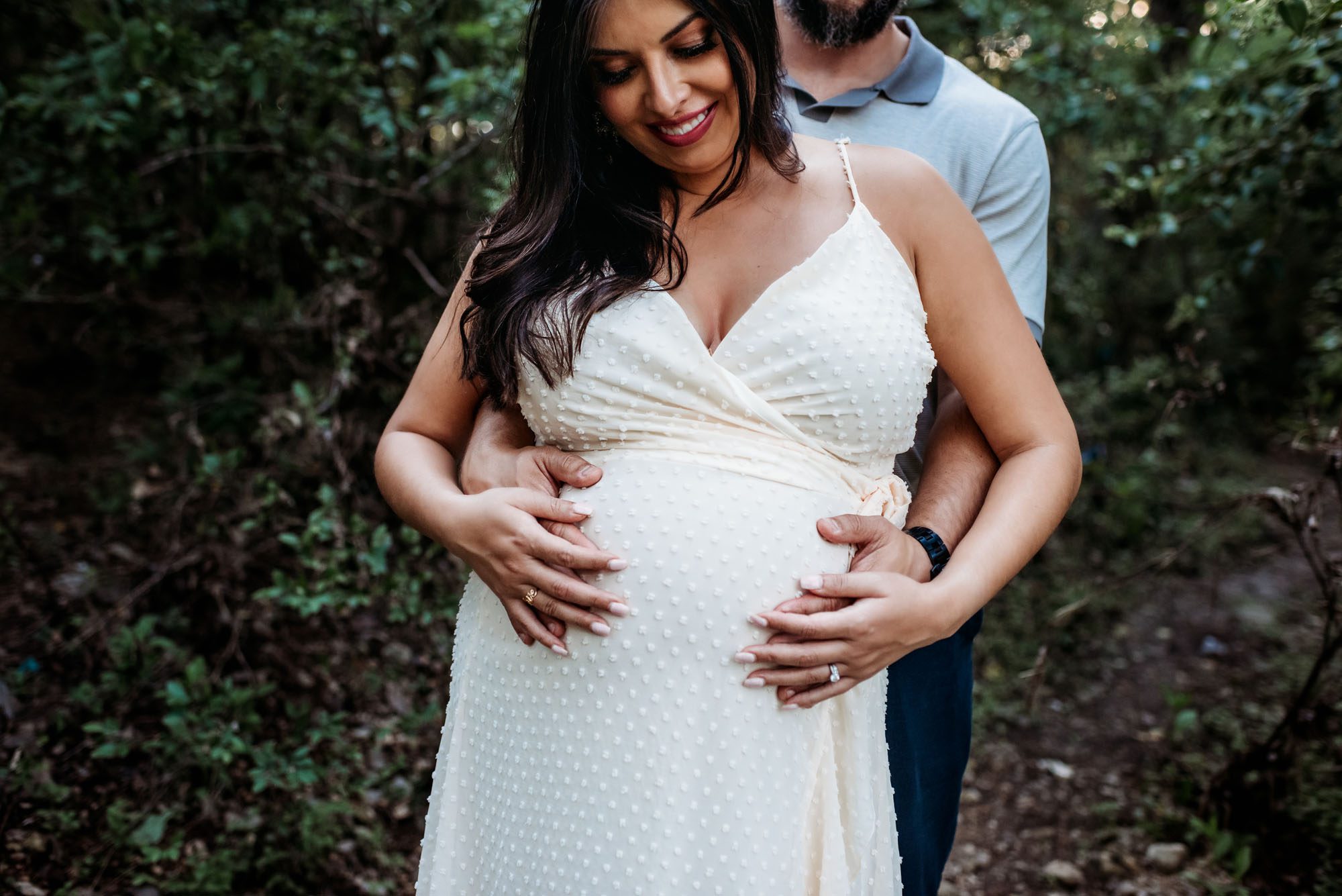 Expectant mother looking at her belly, San Antonio Maternity Photographer