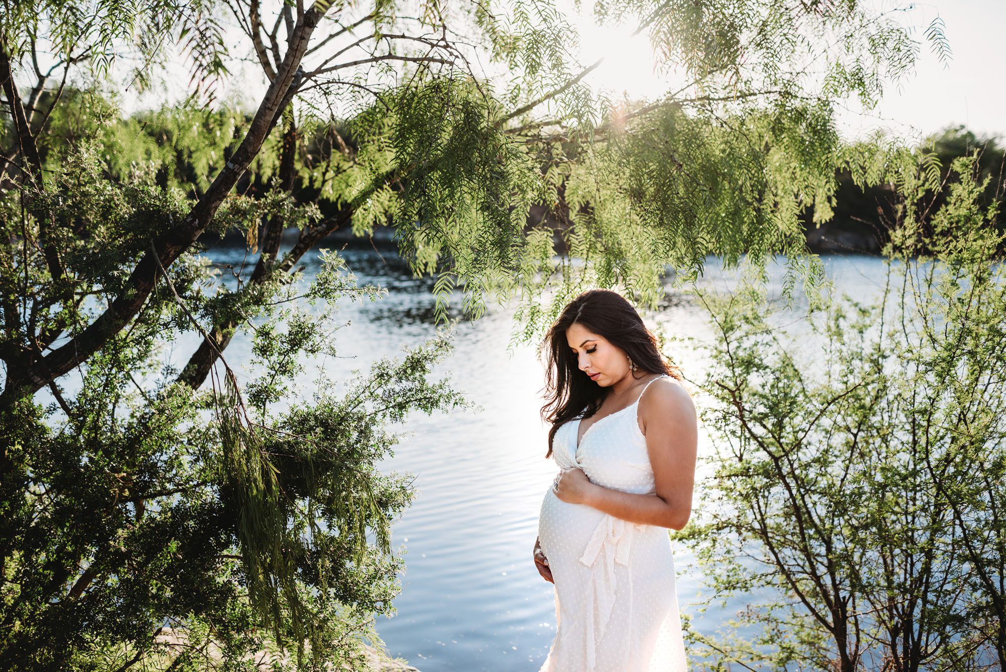 Expectant mother standing near lake and trees, San Antonio Maternity Photographer