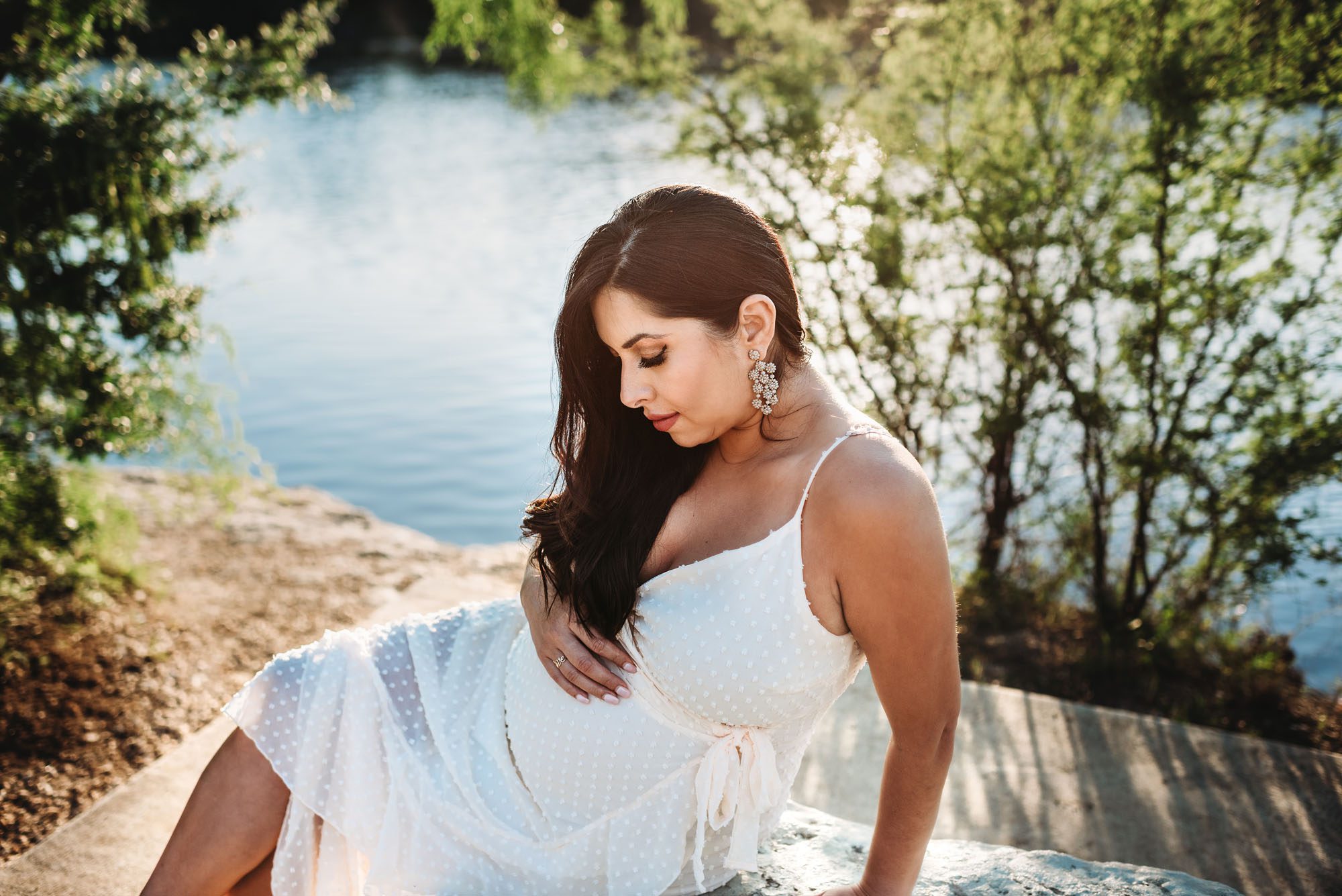Expectant mother sitting near lake, San Antonio Maternity Photography