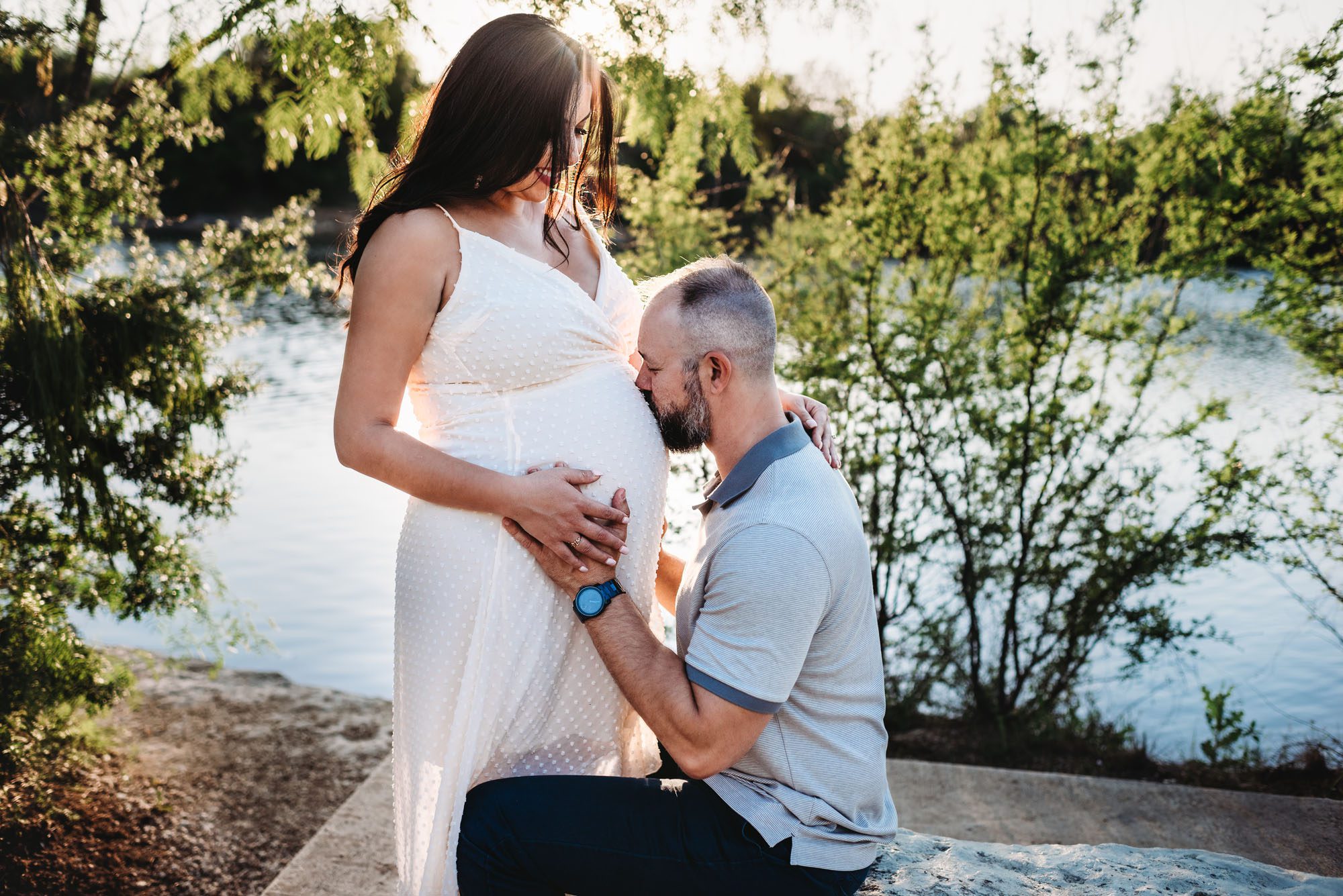 Husband kissing expectant wife's belly, San Antonio Maternity Lifestyle Photographer