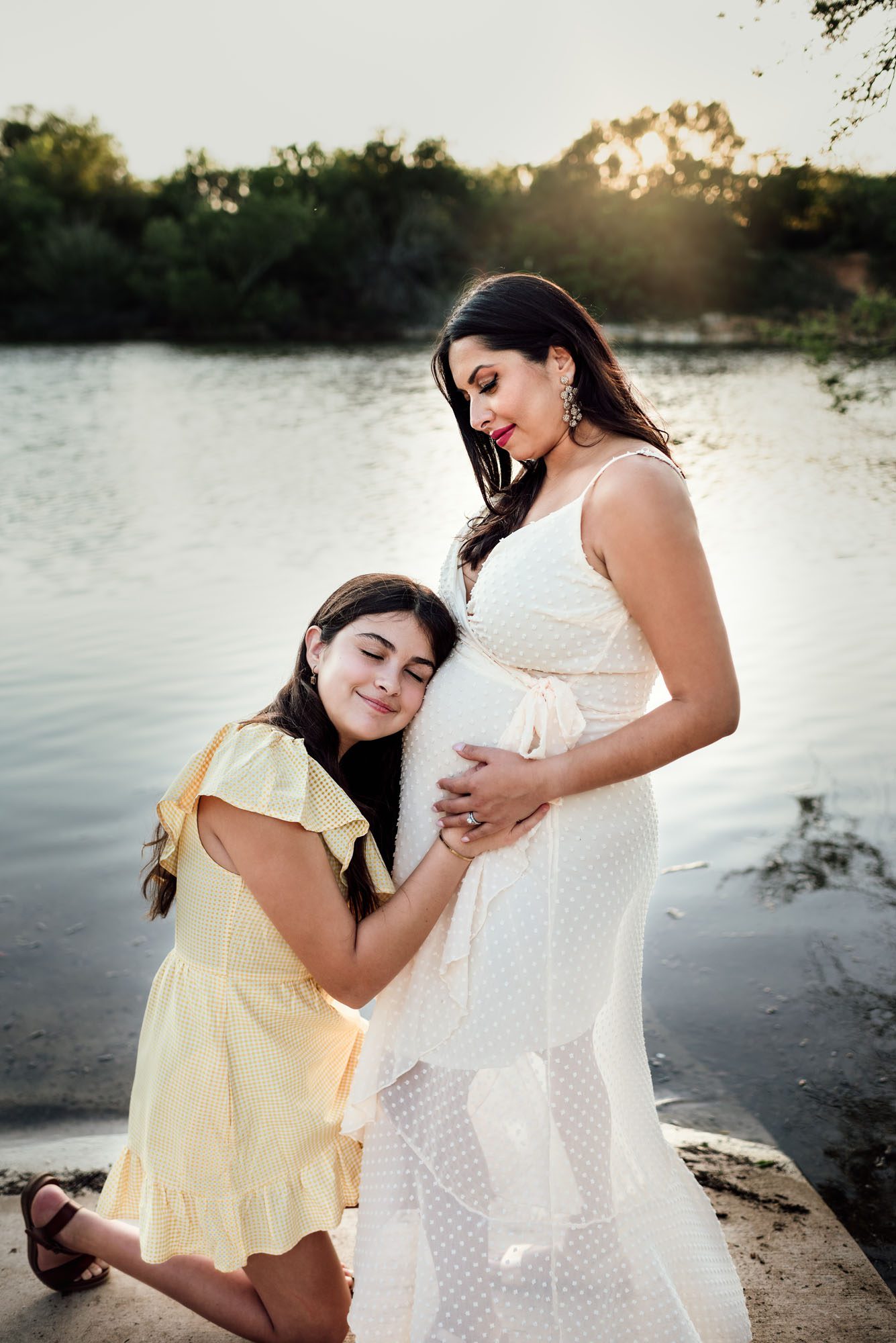 Daughter resting her head on expectant mother's belly, San Antonio Maternity Lifestyle Photographer