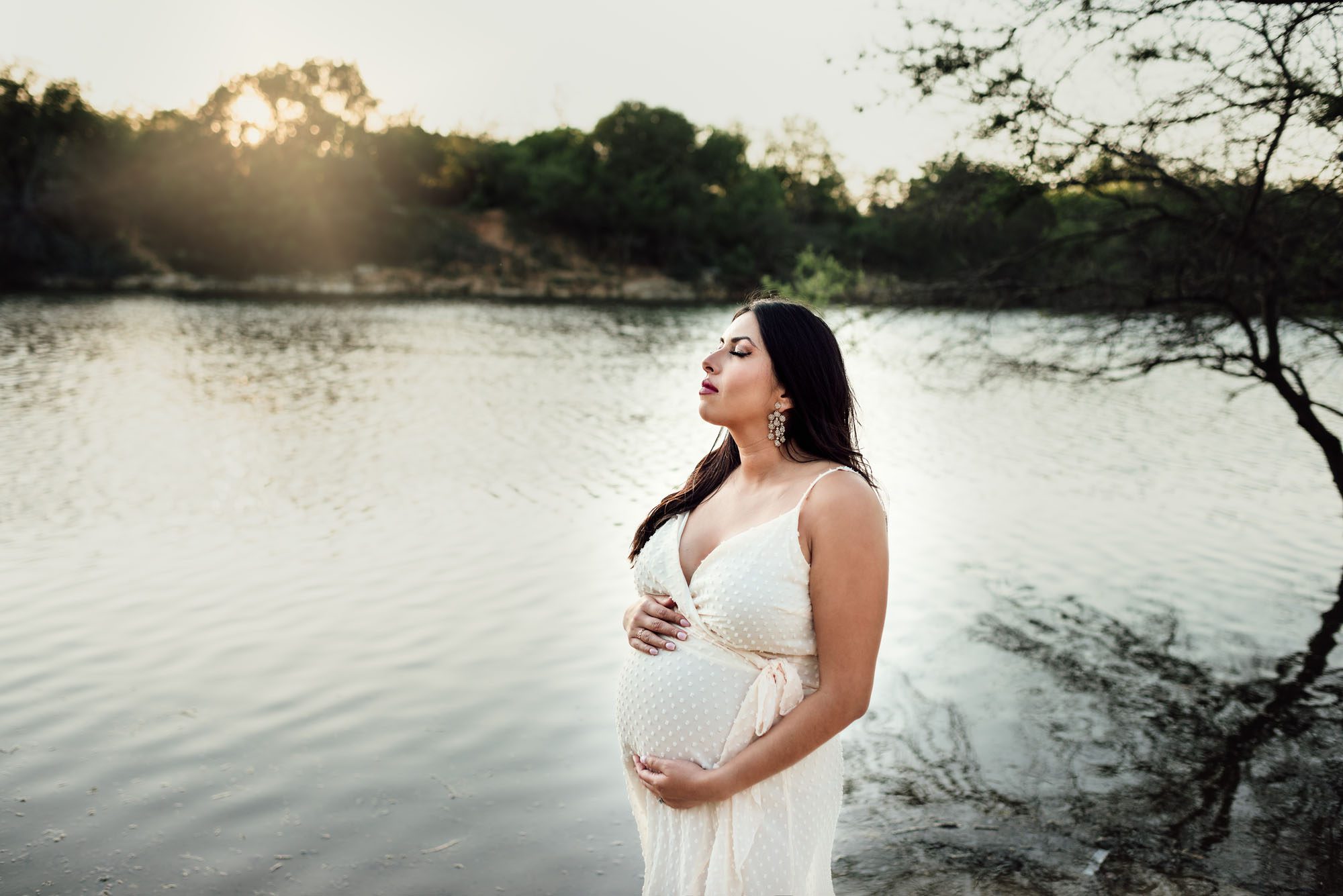 Expectant mother standing by the lake at sunset, San Antonio Maternity Lifestyle Photographer