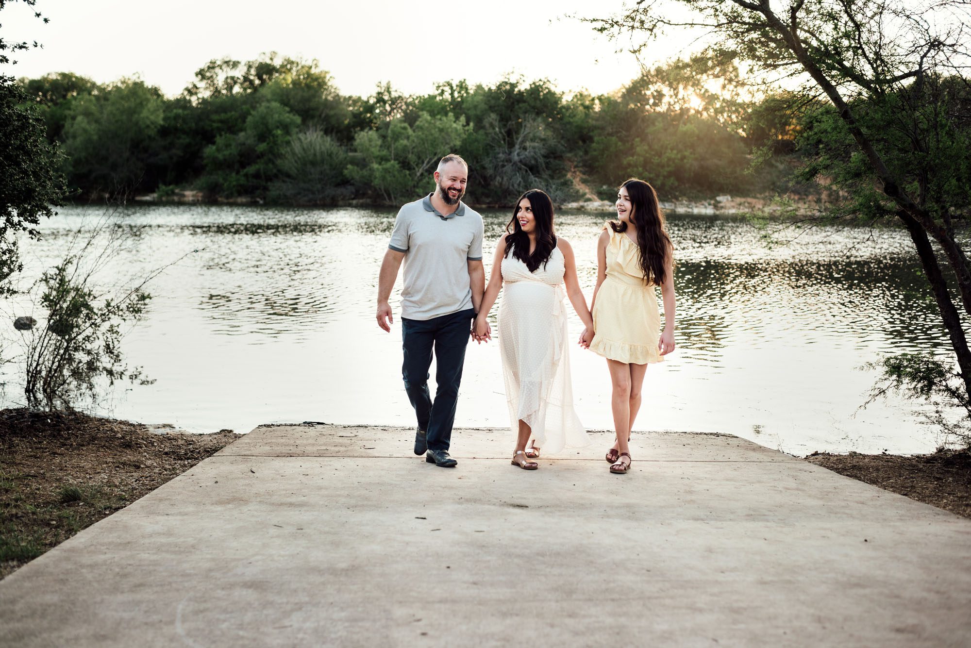 Family holding hands by the lake, San Antonio Maternity Photographer