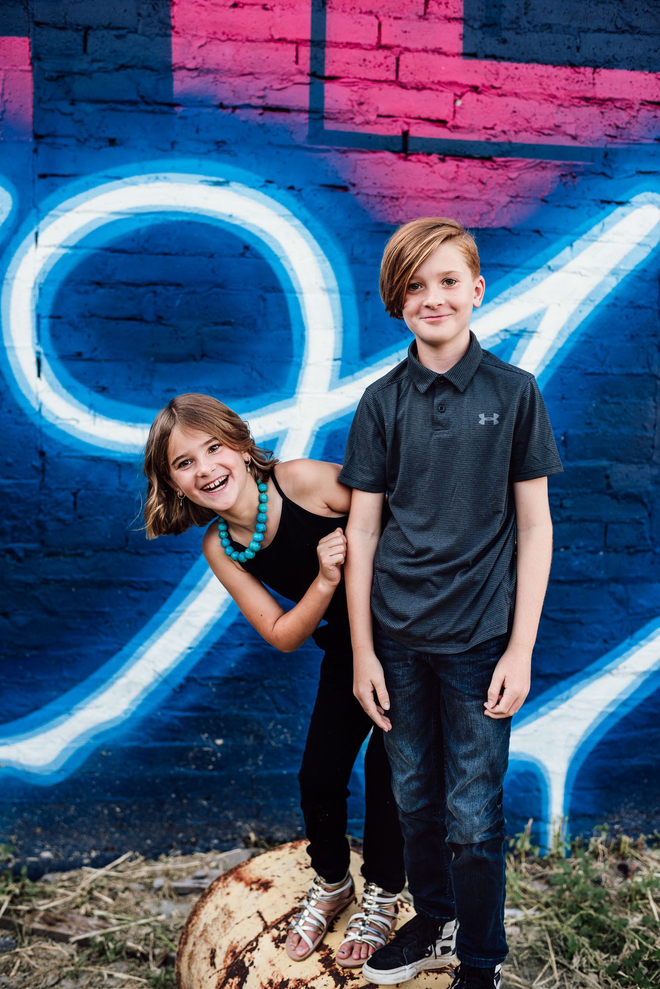Boy and girl in front of a grafitti wall, San Antonio lifestyle photographer