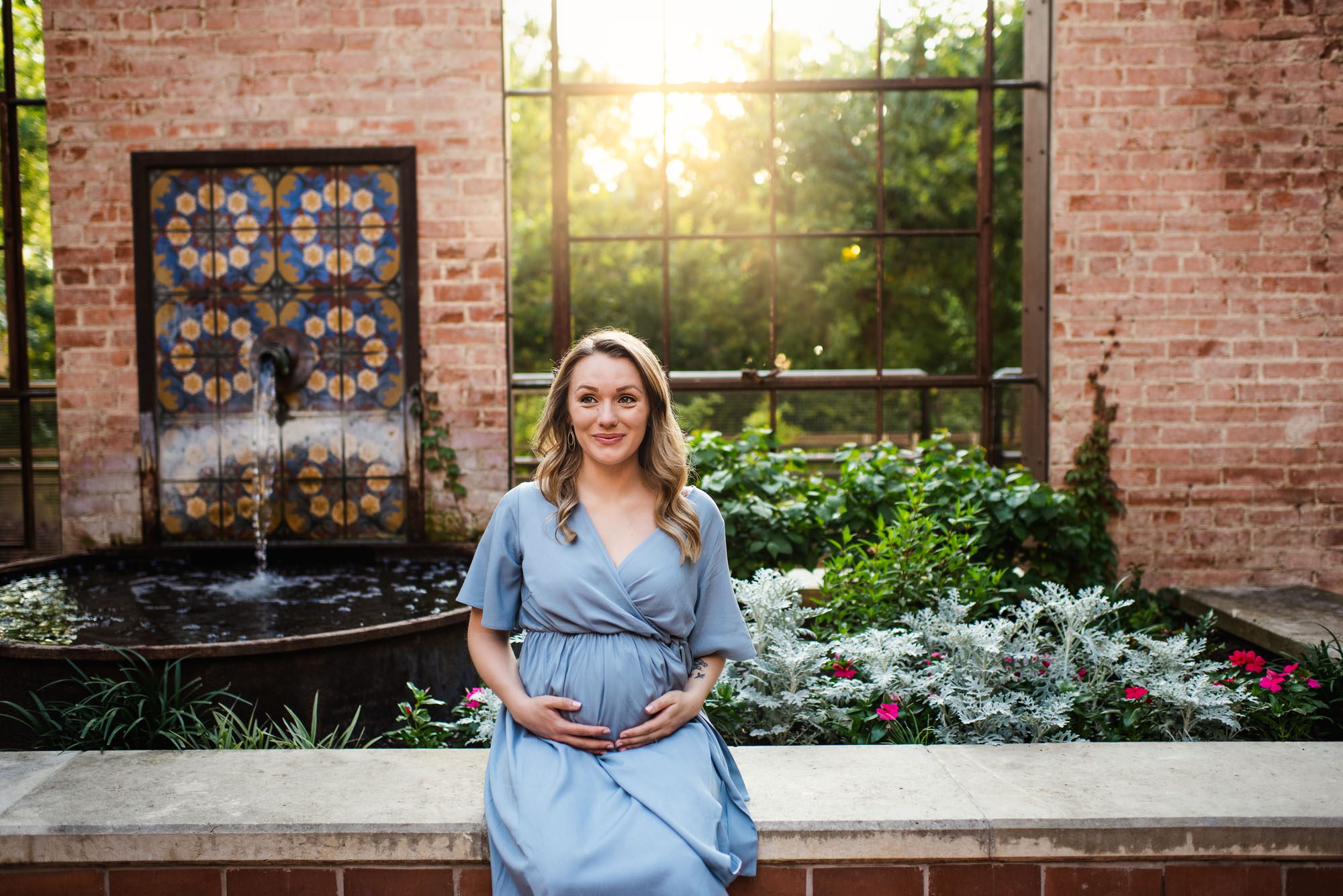 Expectant mother sitting near fountain, San Antonio maternity photographer