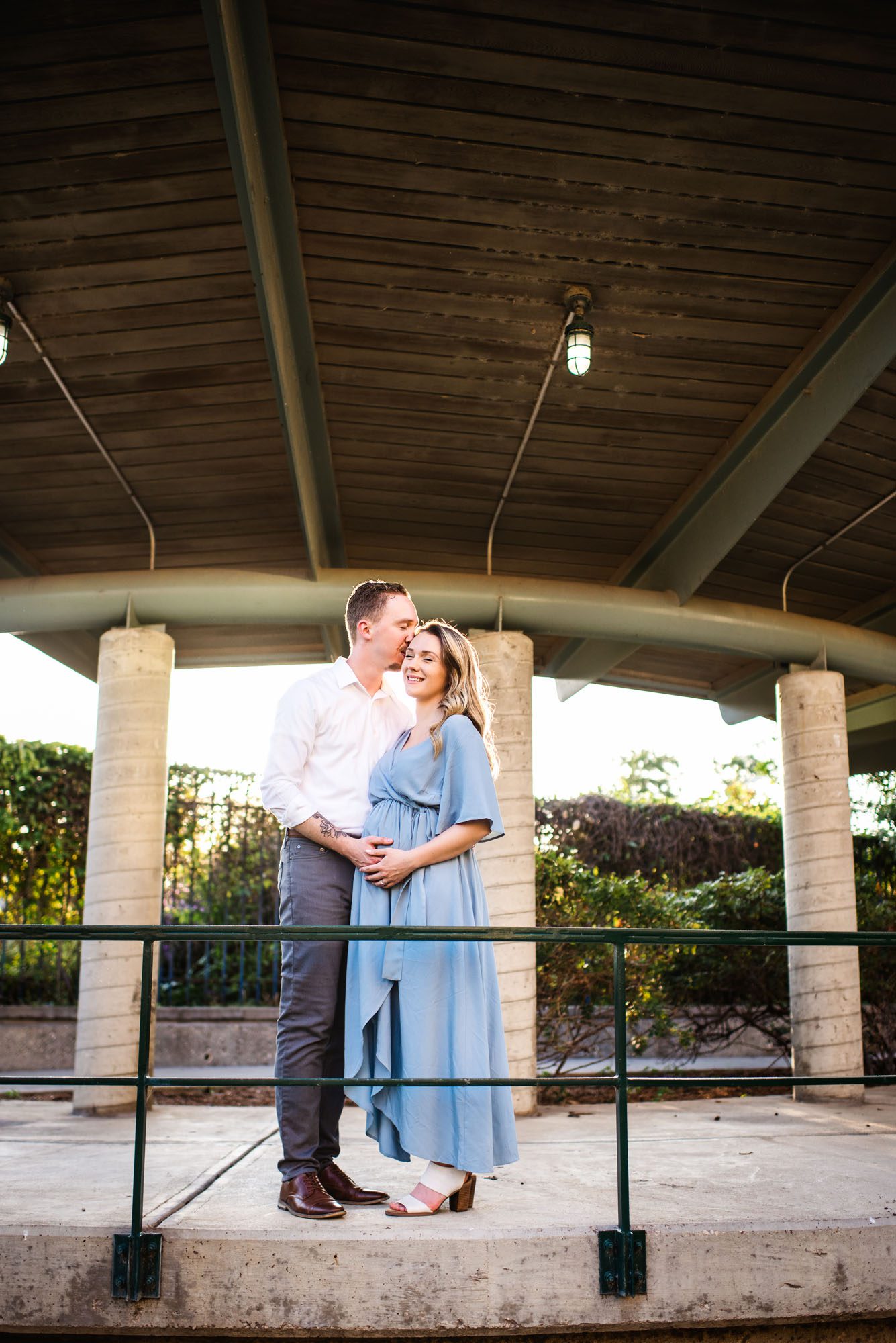 Expectant couple kissing under pavilion, San Antonio maternity photographer