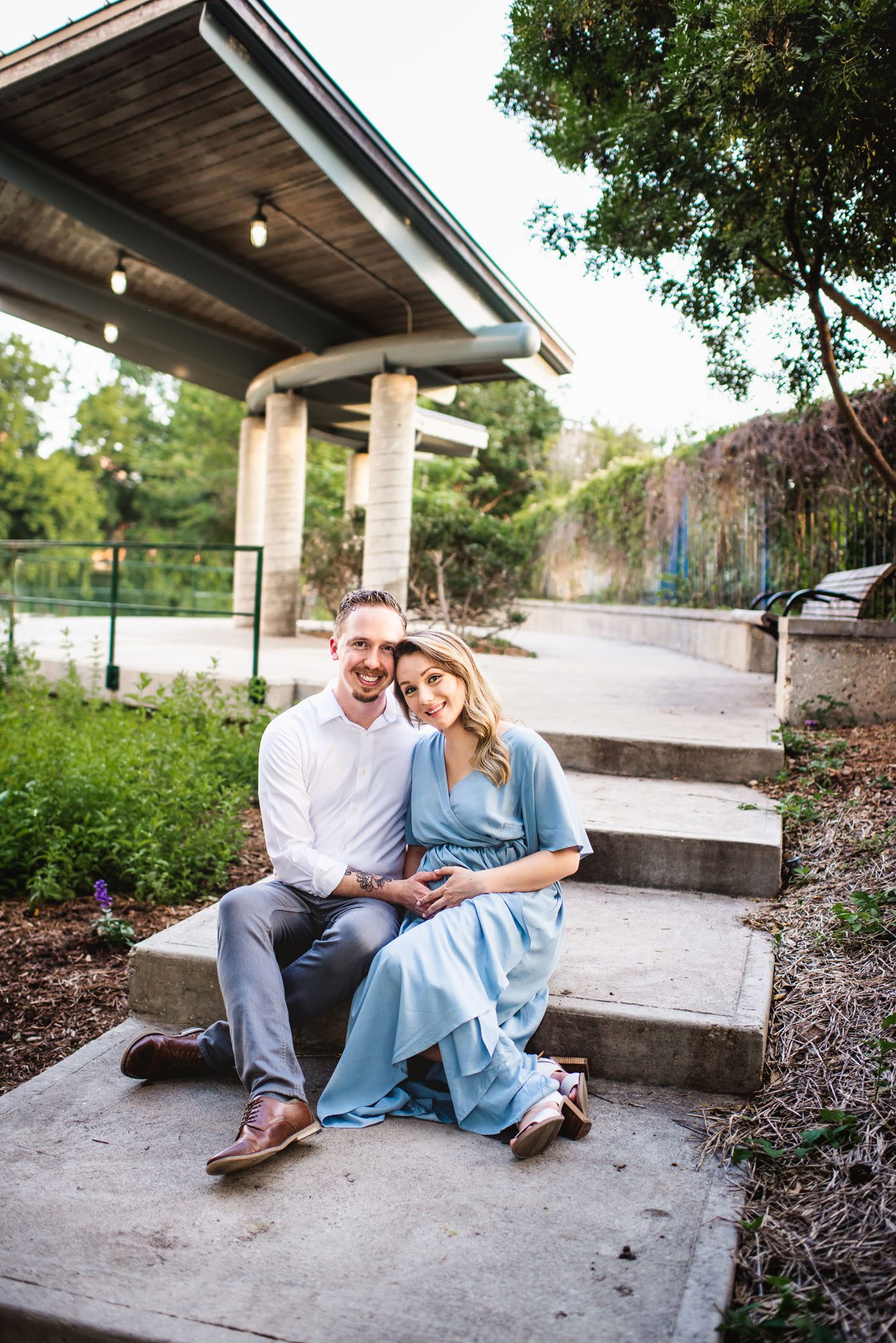 Couple sitting by pavilion, San Antonio maternity photographer