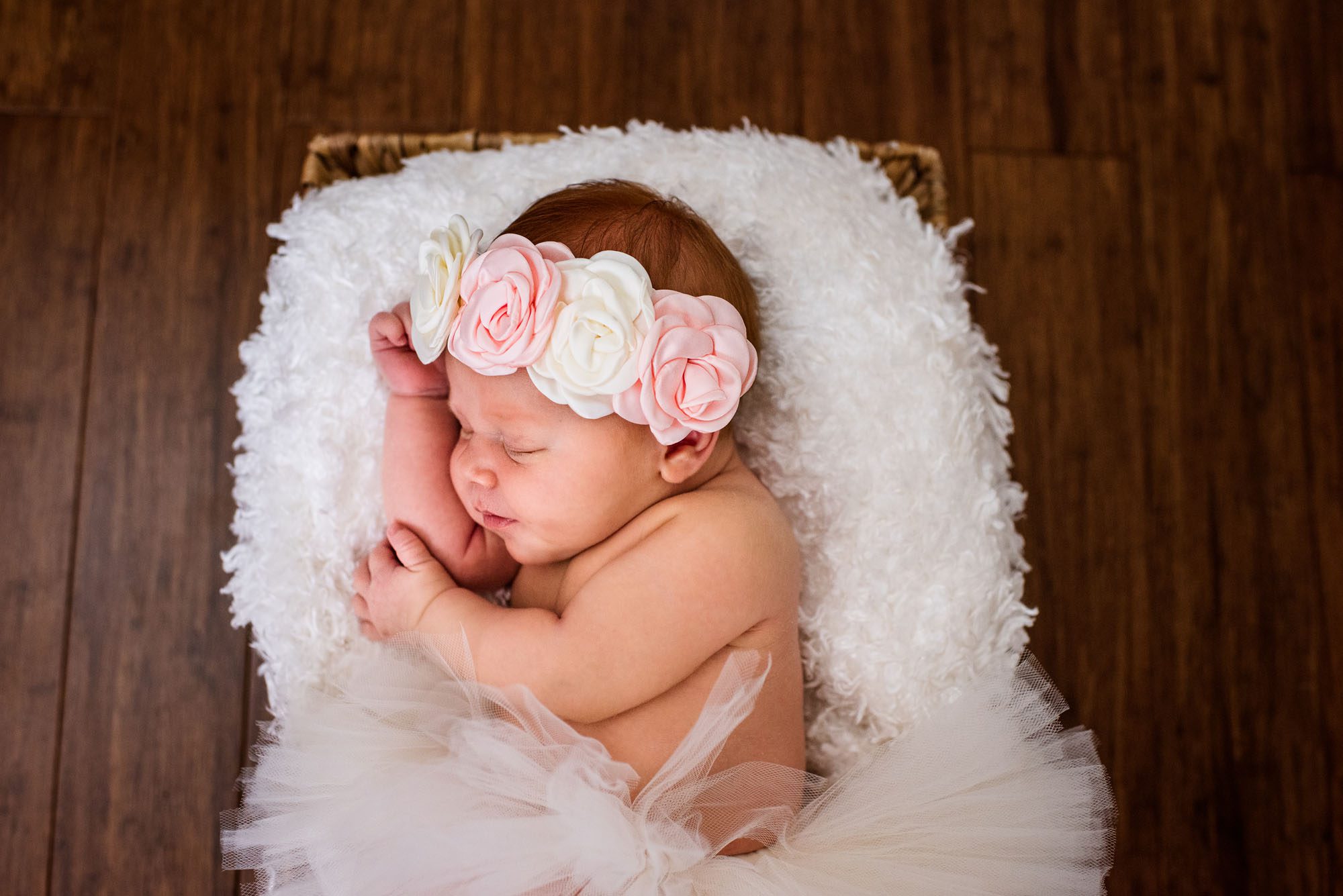 Newborn baby sleeping in basket with flower headband, San Antonio Newborn Photographer