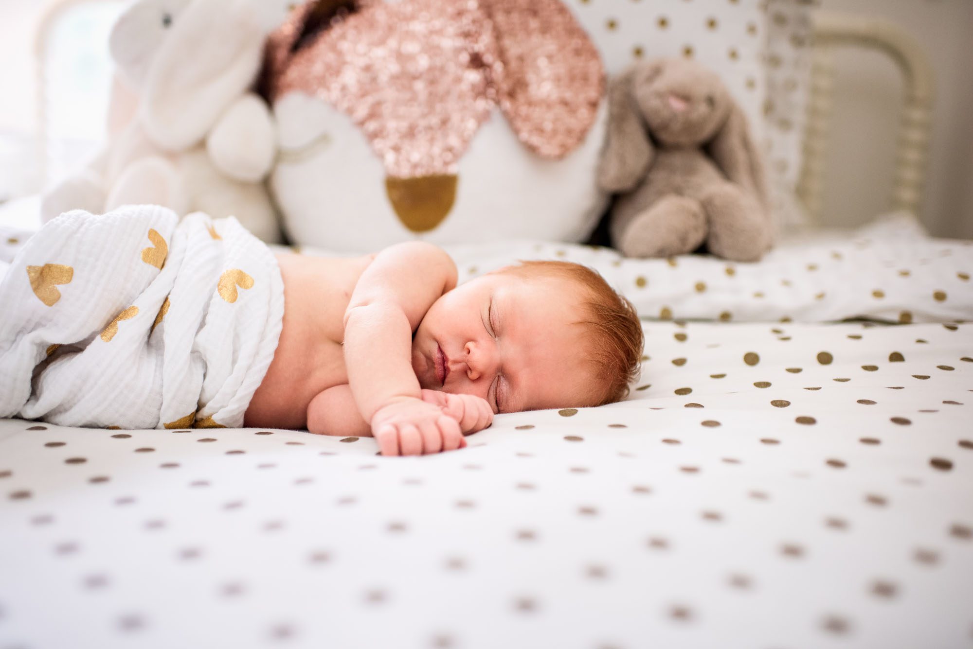 Newborn baby sleeping on bed, San Antonio Newborn Photographer