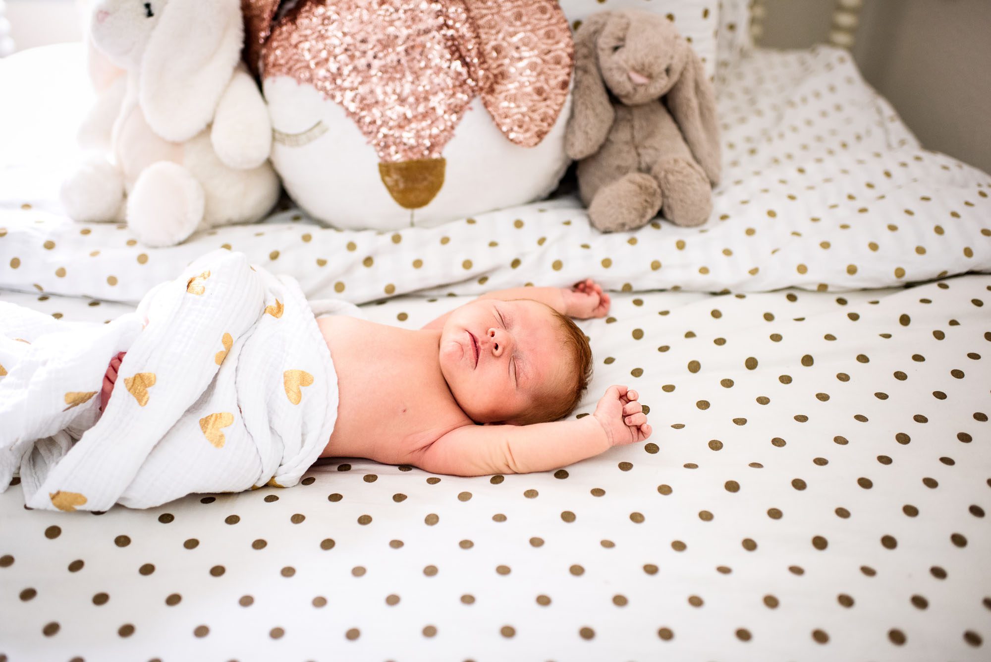 Newborn baby stretching on bed, San Antonio Newborn Photographer