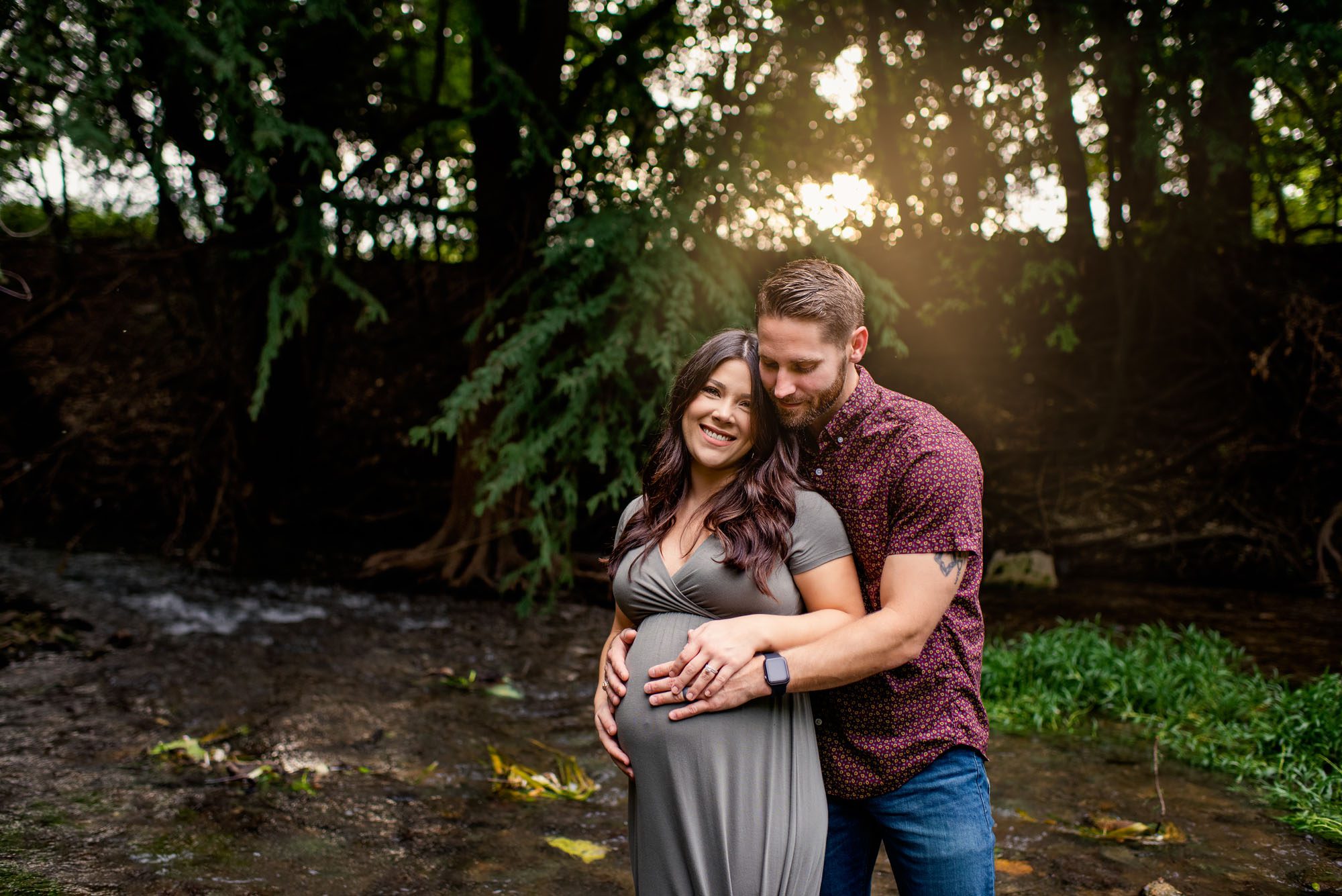 Pregnant couple hugging in creek, San Antonio Maternity Photographer