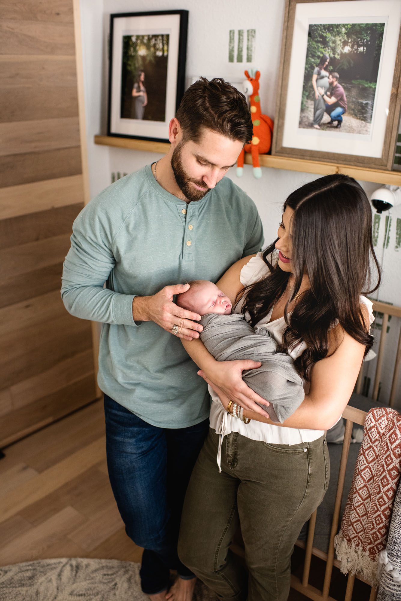 San Antonio Newborn Photographer, Couple holding newborn baby in nursery