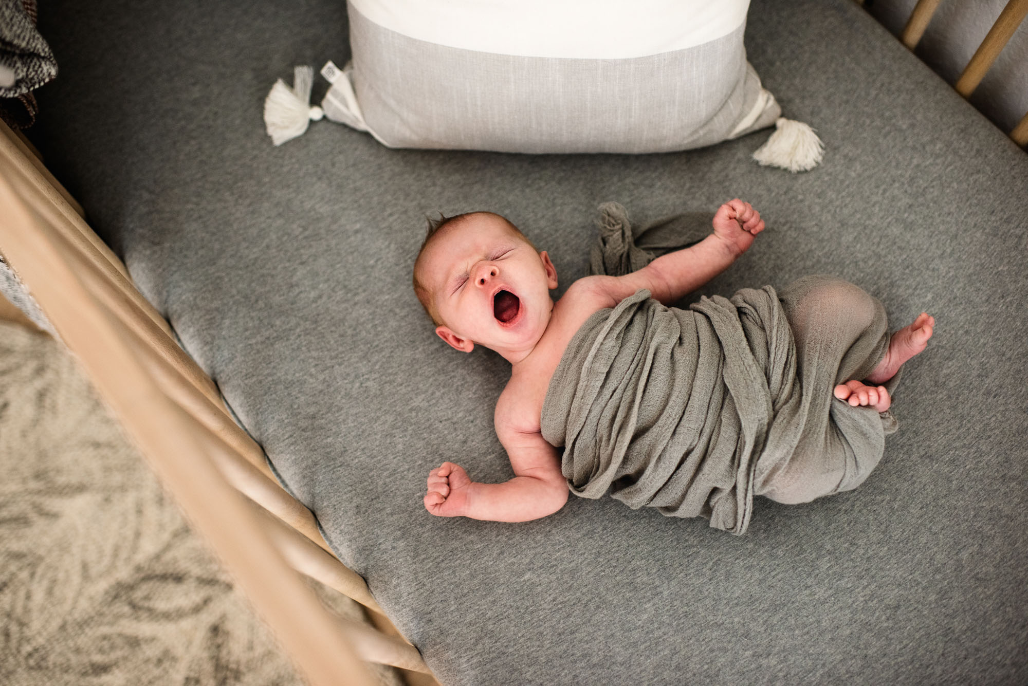 San Antonio Newborn Photography, Newborn baby stretching in crib