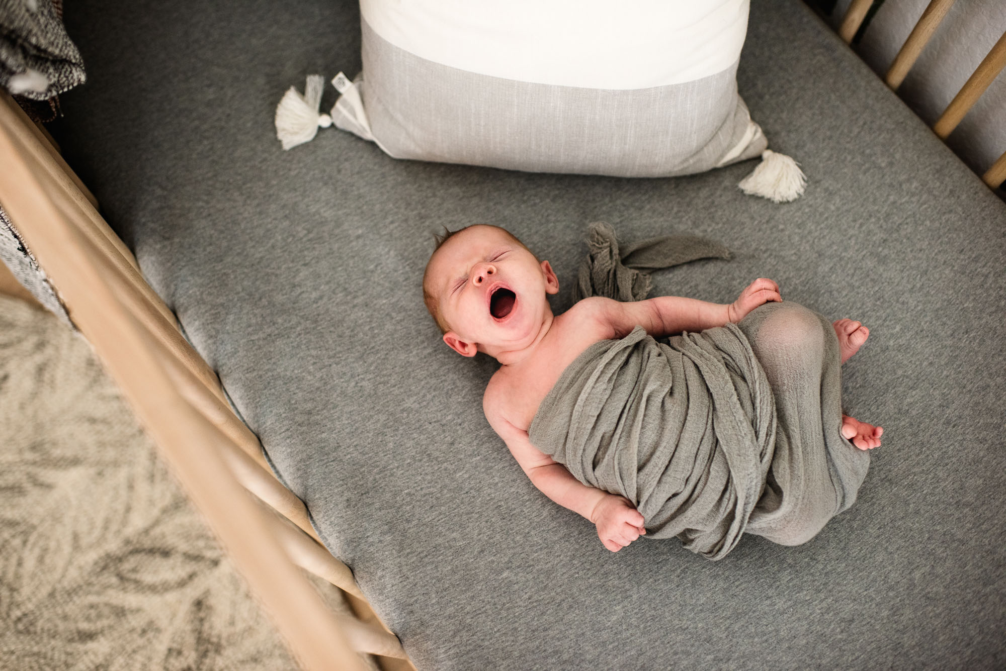San Antonio Newborn Photographer Newborn baby stretching in crib