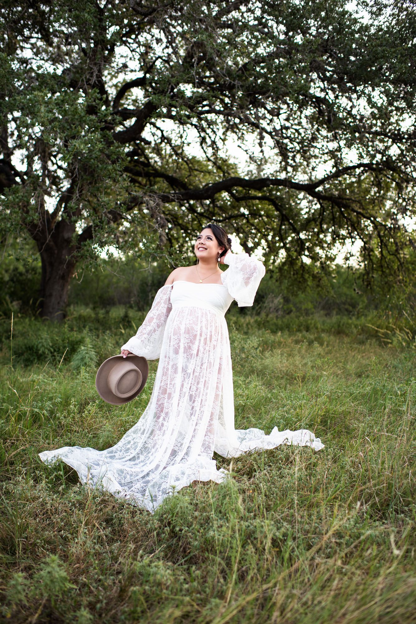 Pregnant mom looking up at the sky in white dress, San Antonio lifestyle photographer