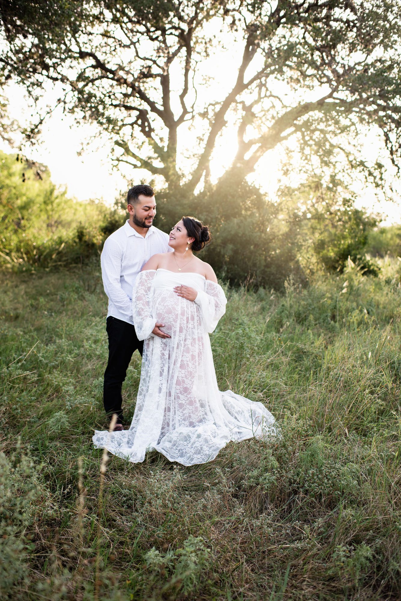 Expectant couple looking at each other lovingly, San Antonio maternity lifestyle photographer