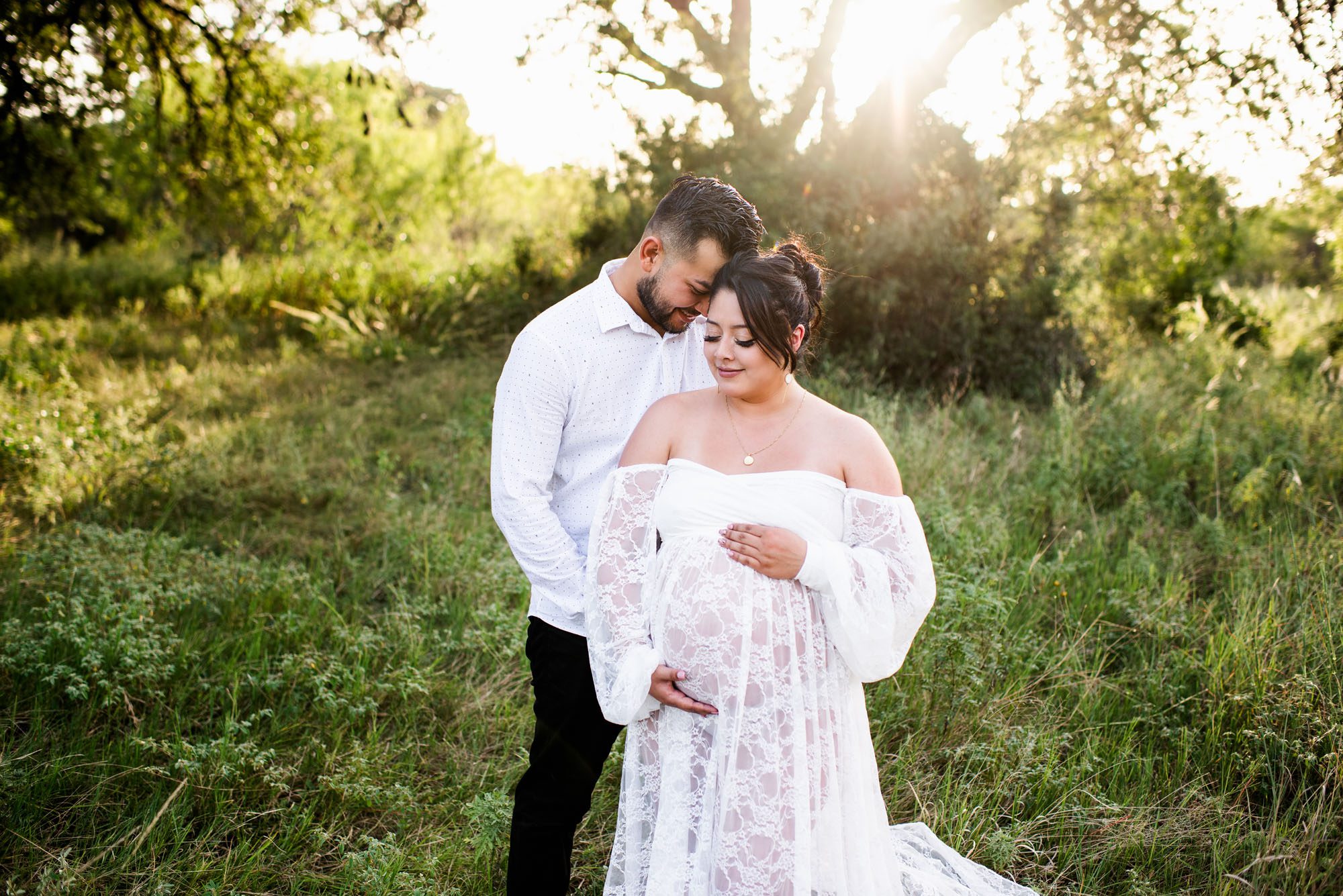 Expectant couple standing together in field at sunset, Best San Antonio maternity lifestyle photographers