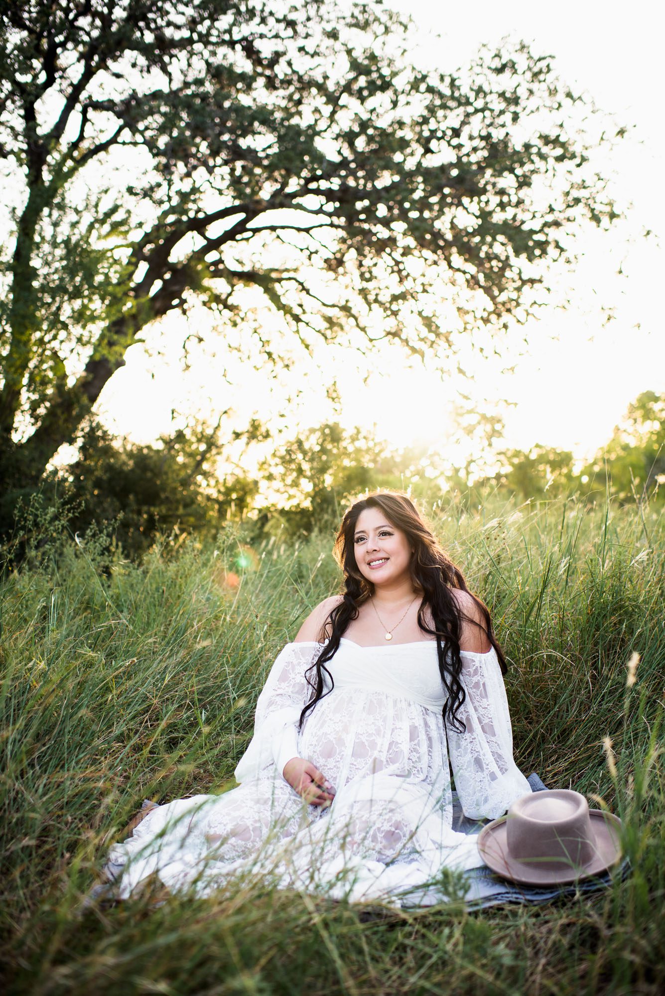 Pregnant Mother sitting in white lace dress, San Antonio maternity lifestyle session