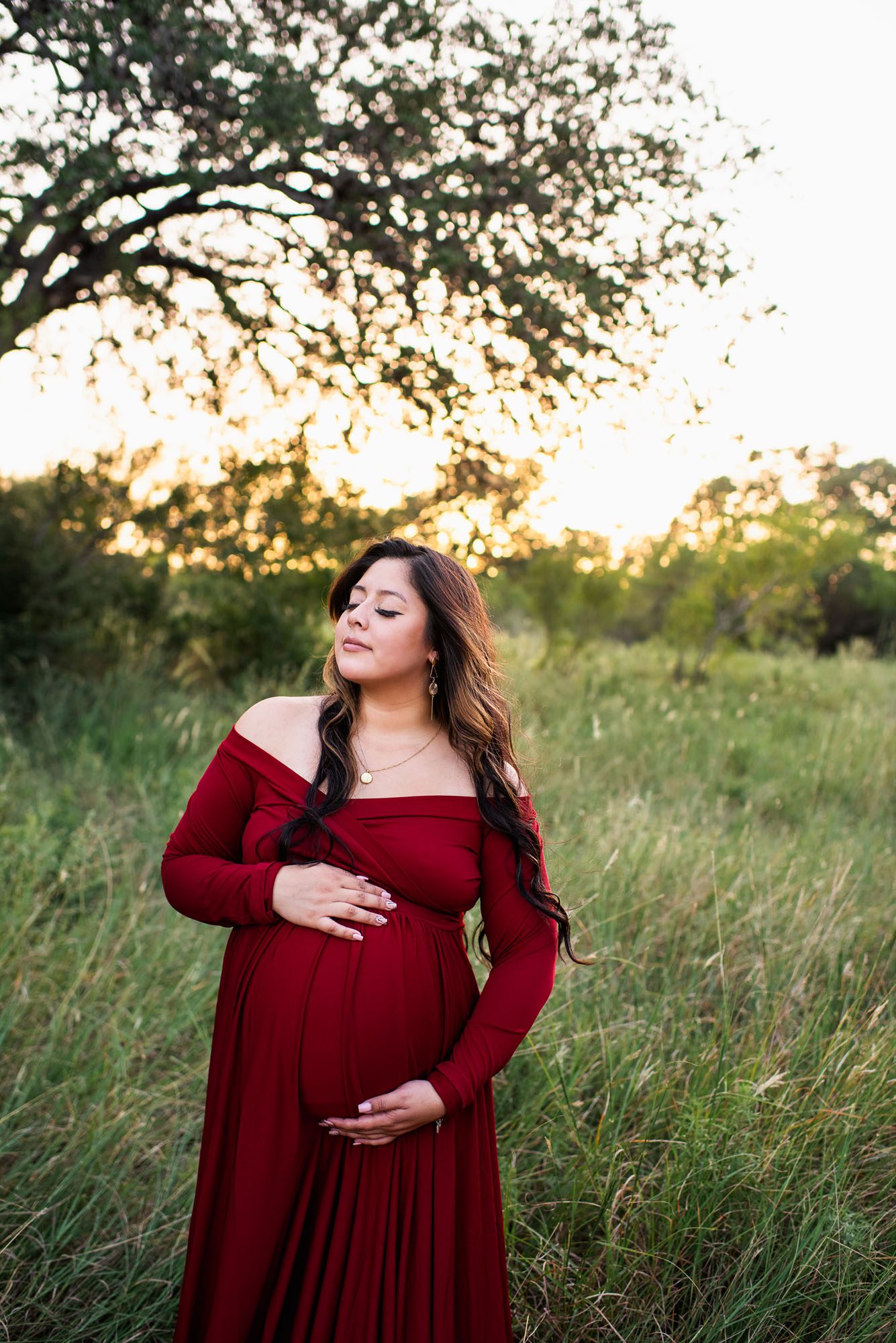 Pregnant mother in long red dress with eyes closed, San Antonio Maternity Photographer
