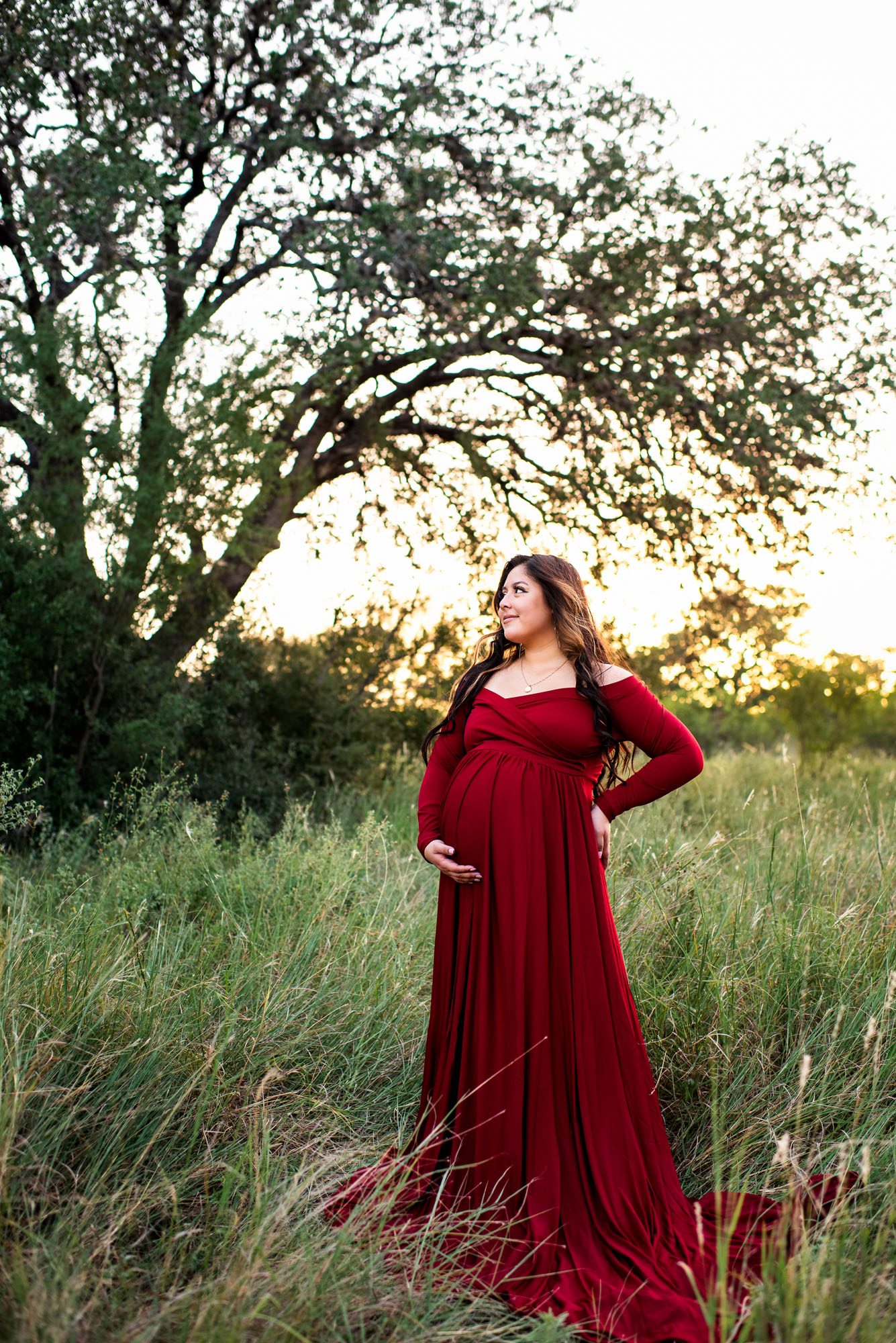 Pregnant mother in long red dress at sunset, San Antonio Maternity Photographer