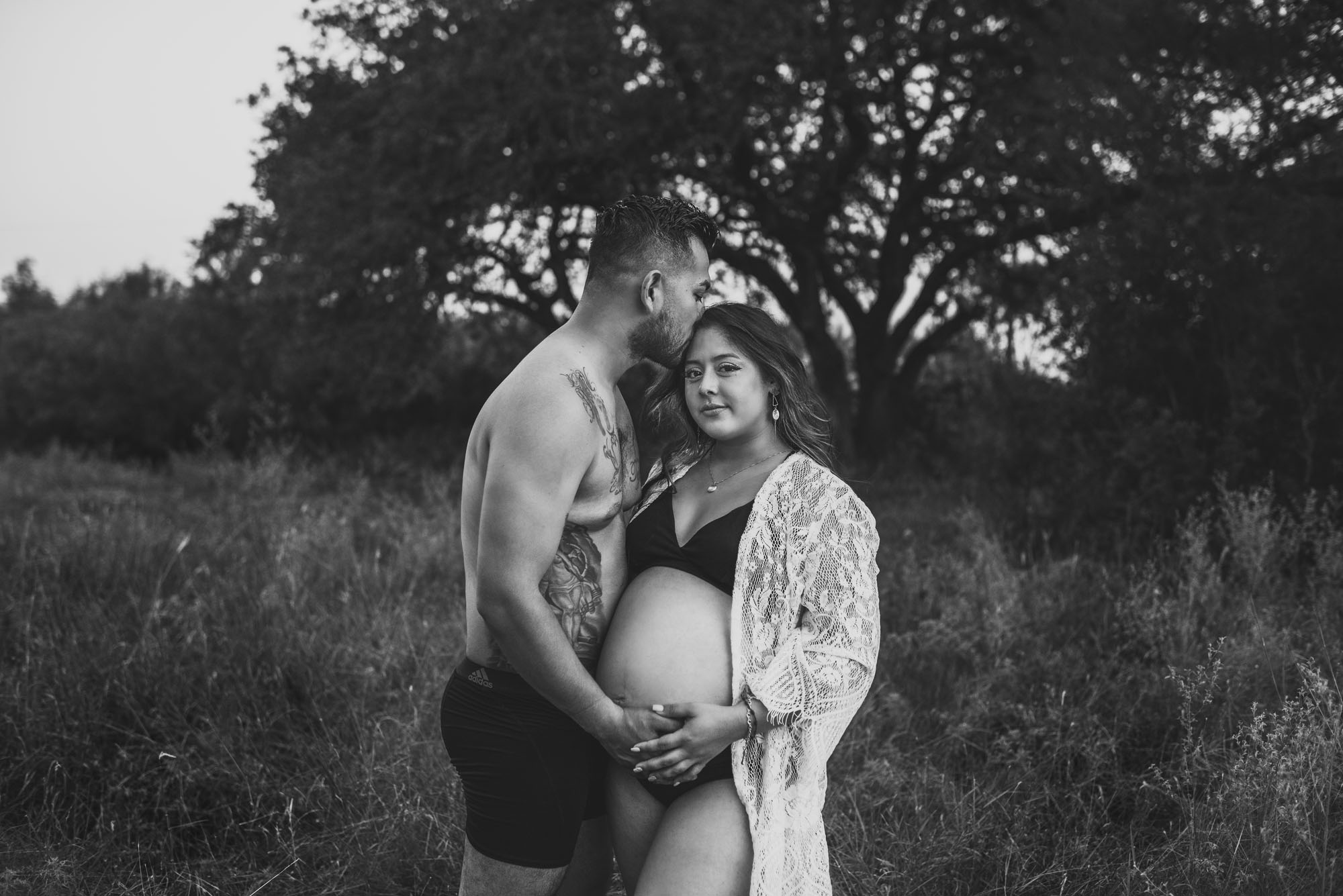 San Antonio Maternity Photographer, Couple standing in a grassy field