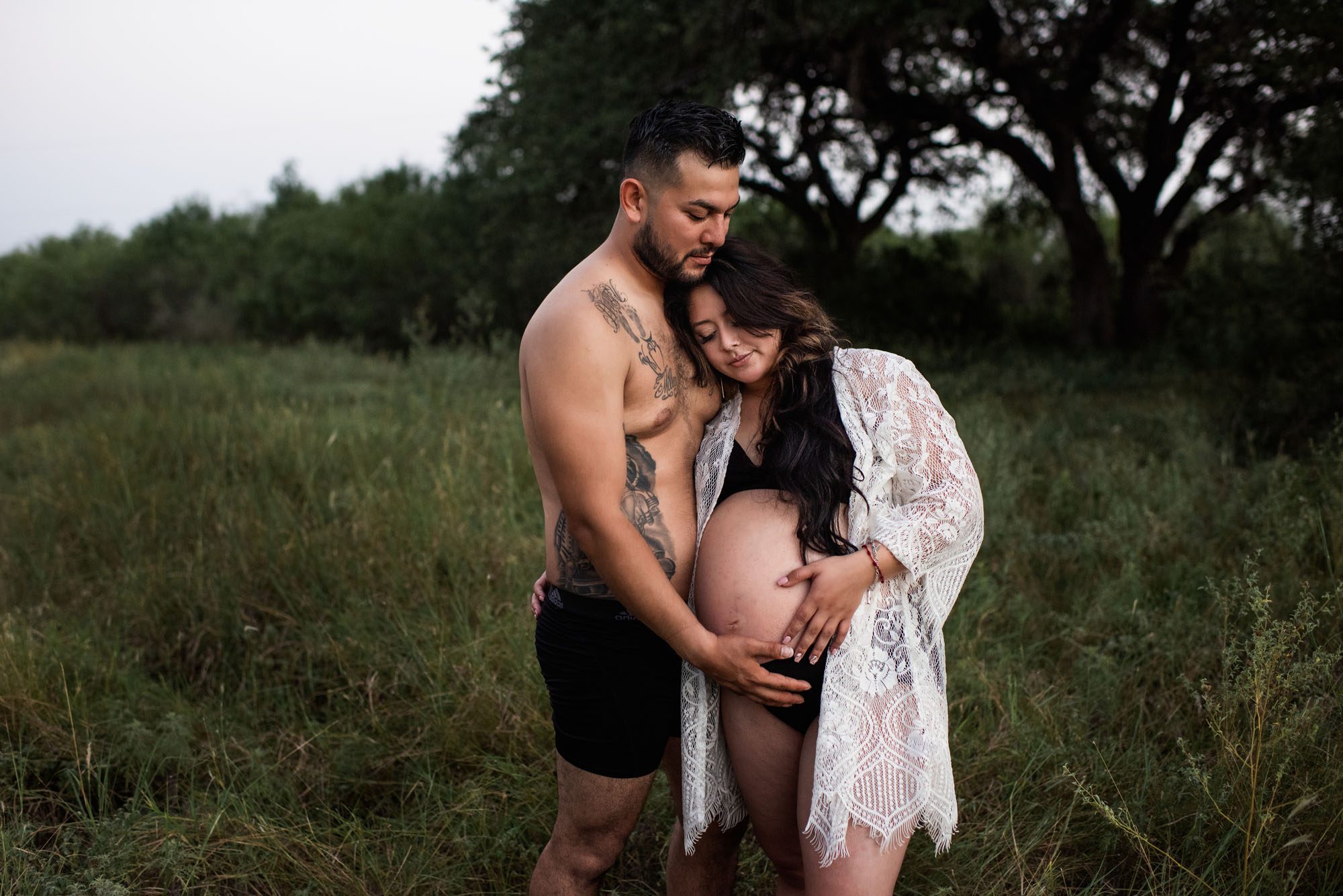 San Antonio Maternity Photographer, Couple standing in a grassy field