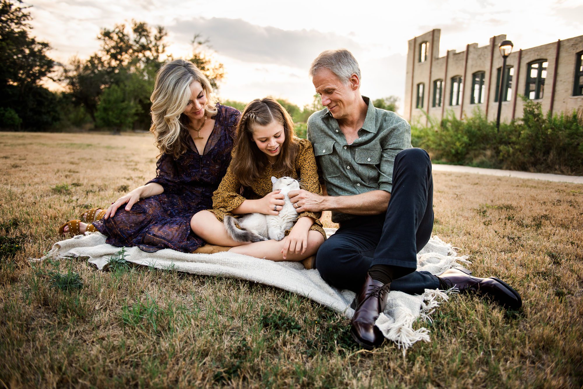 Family sitting with cat in front of old building, San Antonio Lifestyle Family Photographer