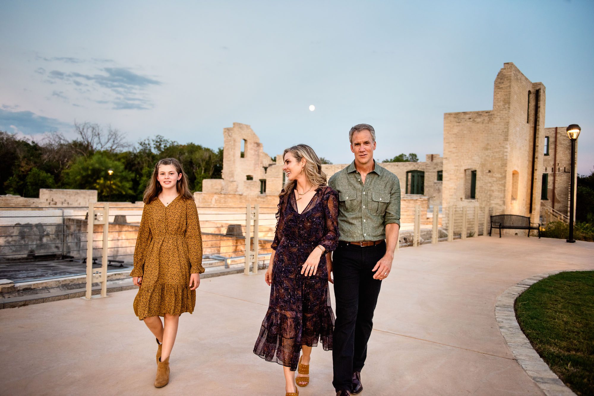 Family walking in front of old building with moon in the sky, San Antonio Lifestyle Photographer