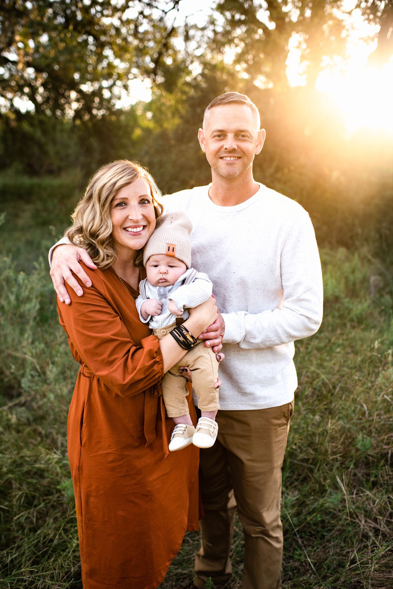 Parents holding newborn baby boy at sunset, San Antonio Family Photographer